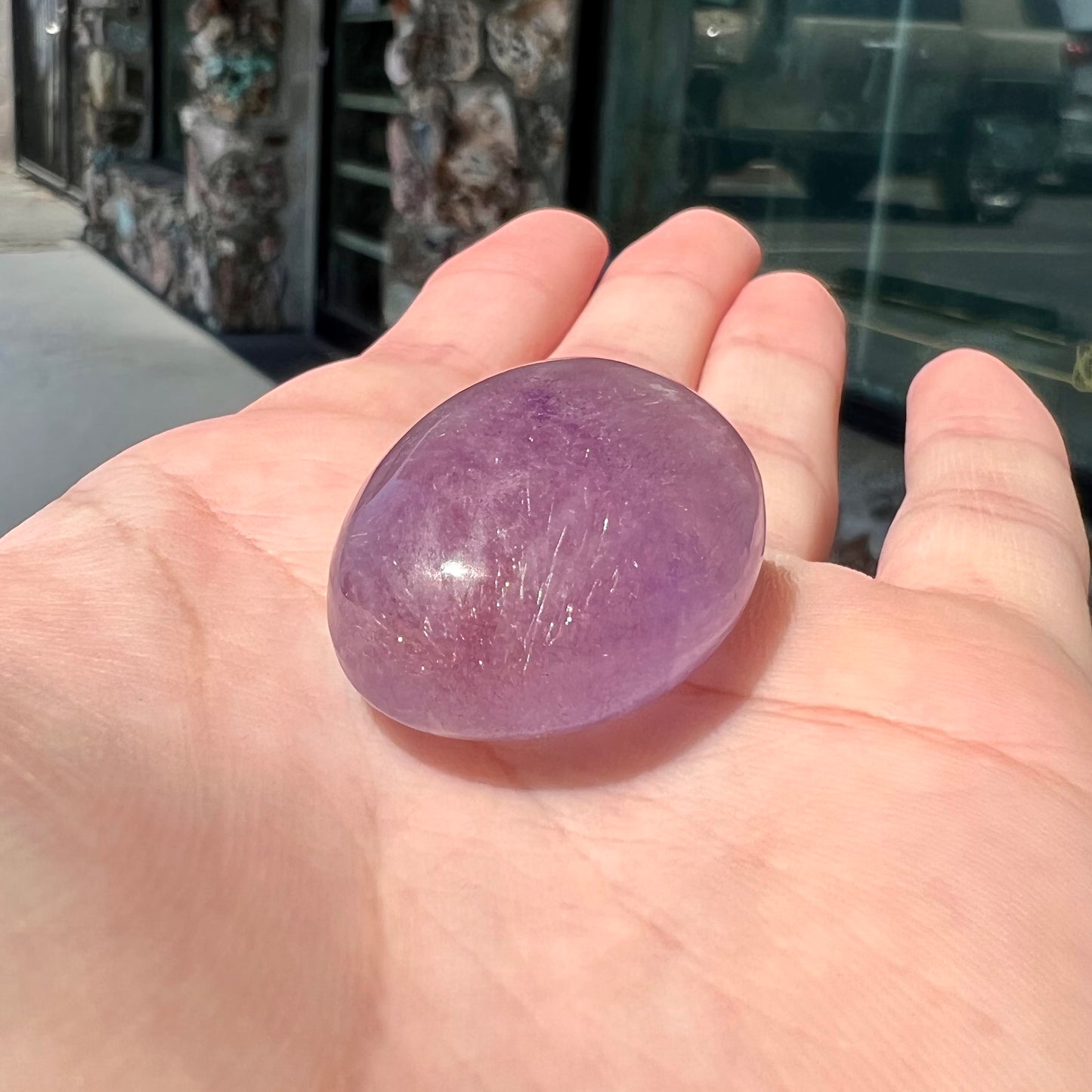 A cabochon cut red amethyst stone from Mexico. The piece shows a faint star.