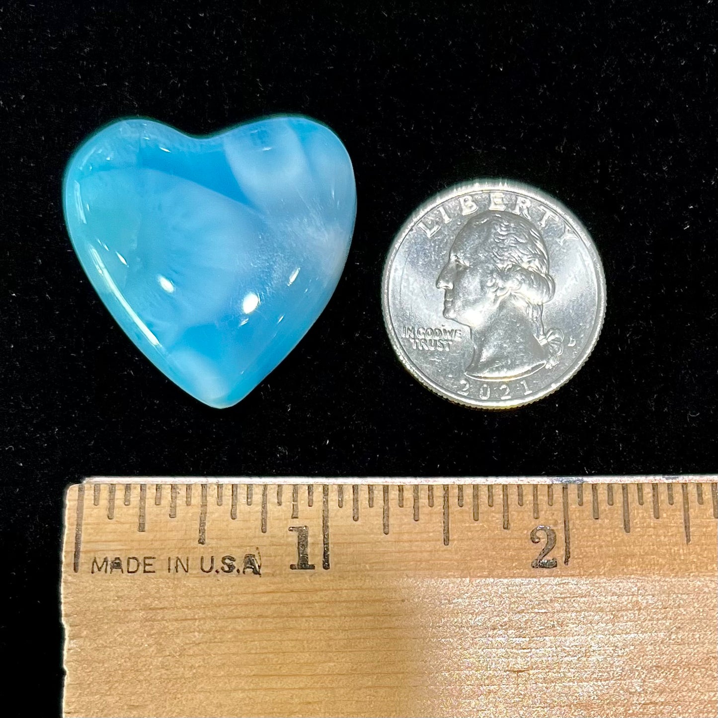 An AAA+ grade larimar stone cut into a heart shaped cabochon.