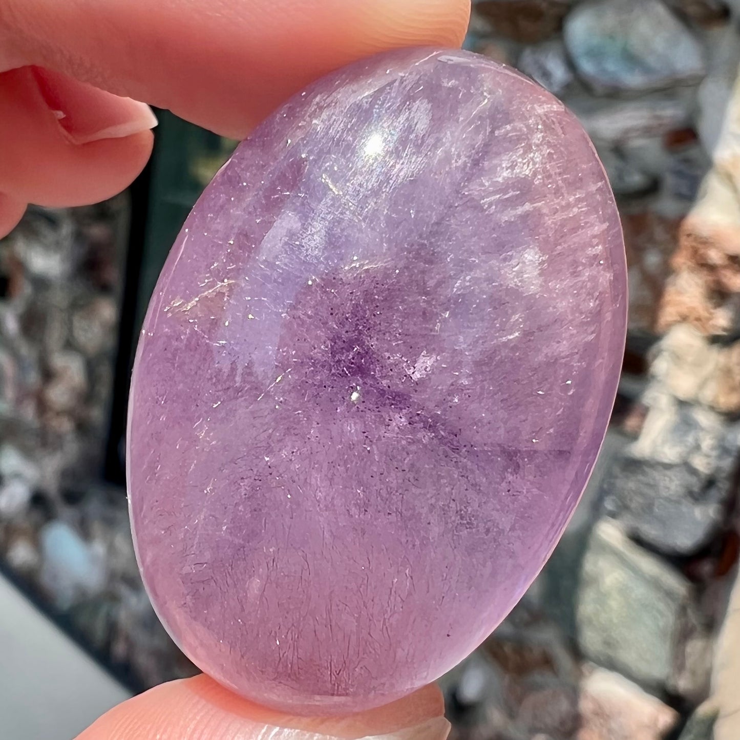 A cabochon cut red amethyst stone from Mexico. The piece shows a faint star.