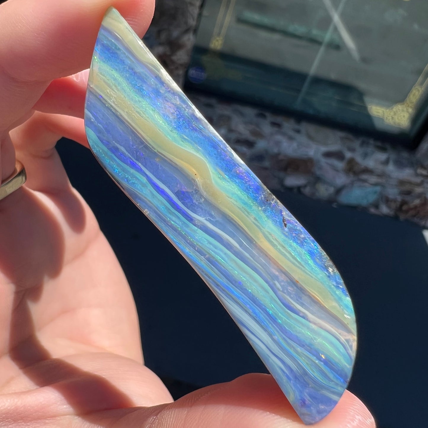 A large, loose, polished Quilpie boulder opal stone from Queensland, Australia. The stone is blue.