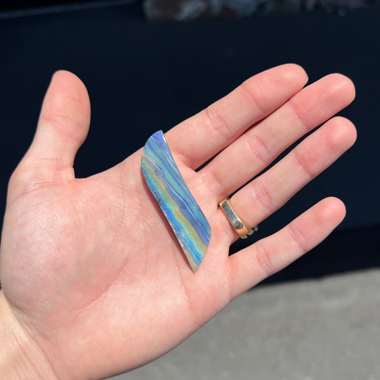A large, loose, polished Quilpie boulder opal stone from Queensland, Australia. The stone is blue.