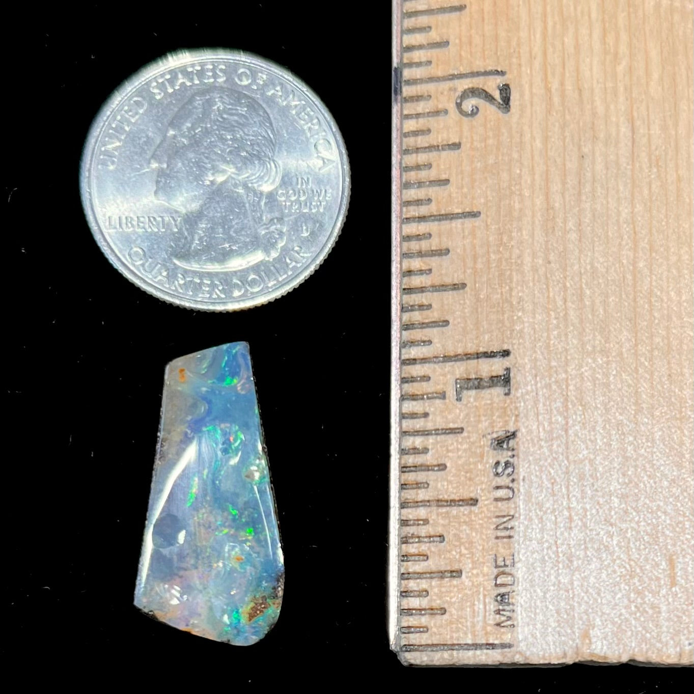 A loose, freeform cut boulder opal stone from Quilpie, Australia.