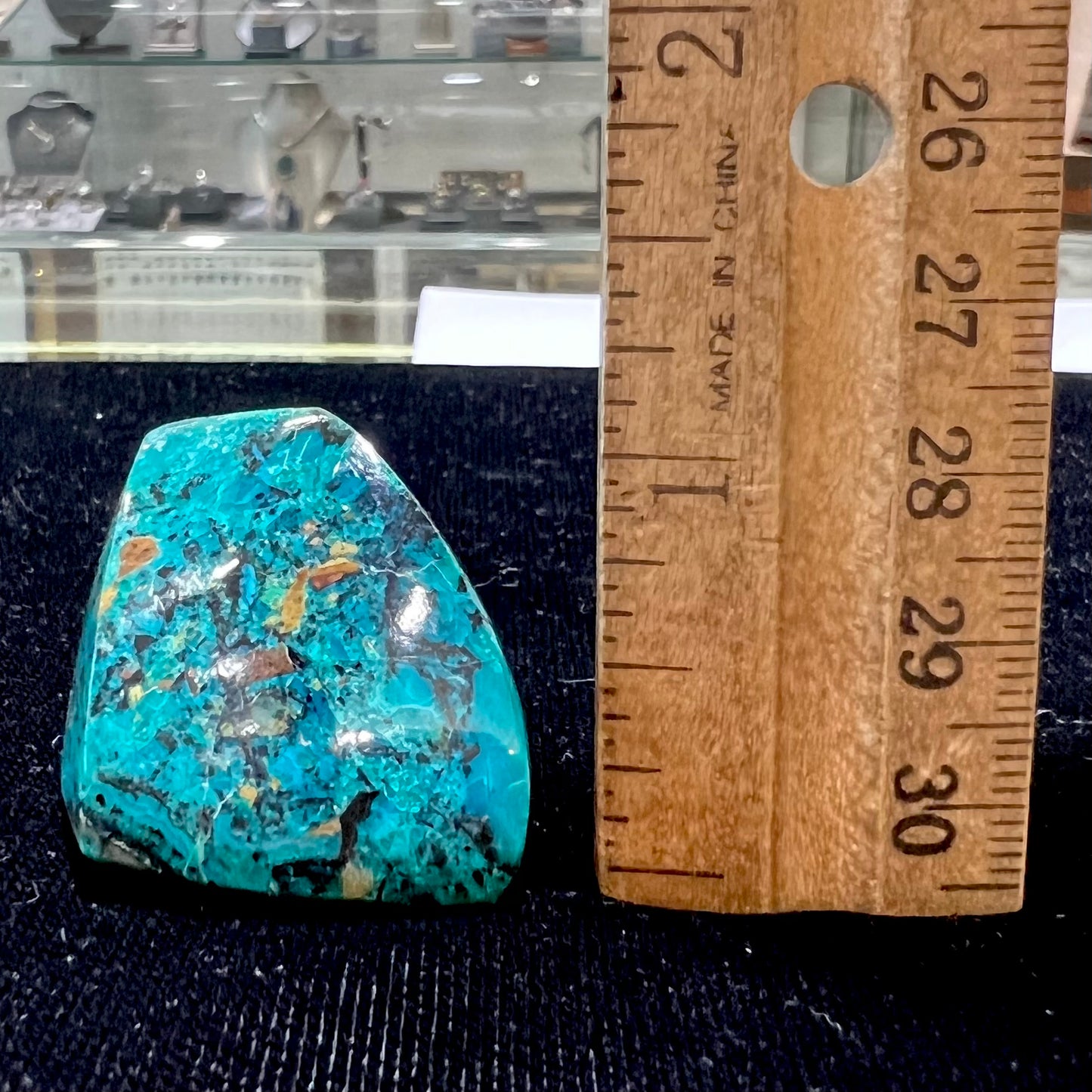 A loose polished chrysocolla specimen that has a crackled effect.