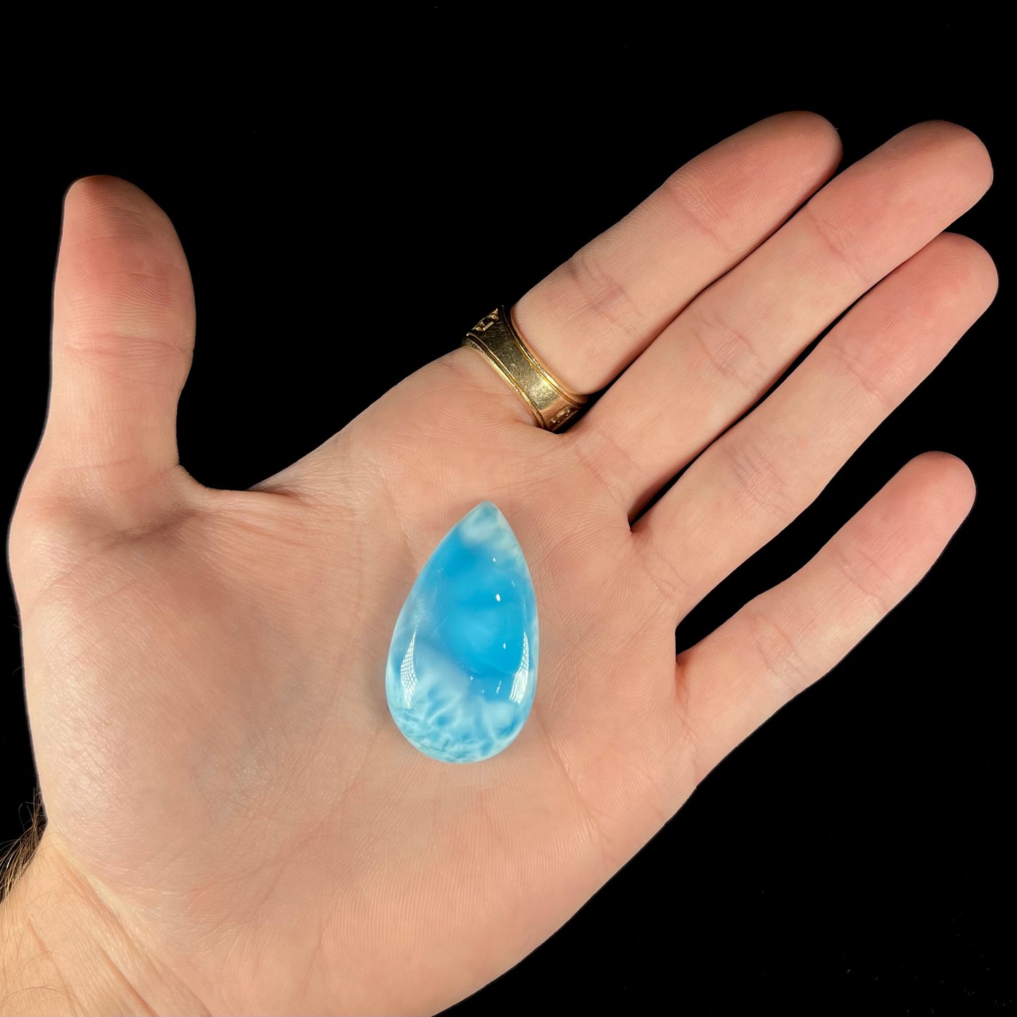 A loose, pear shaped larimar cabochon. The material is AAA+ grade.