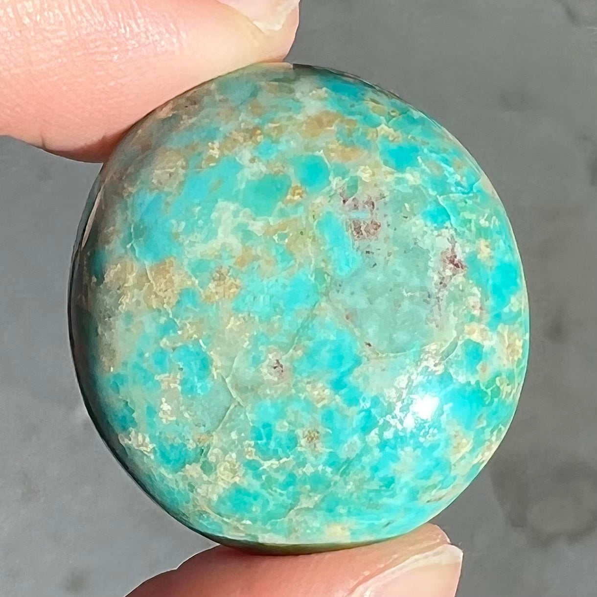 A loose, sky blue, oval cut cabochon turquoise stone from Royston District, Nevada.
