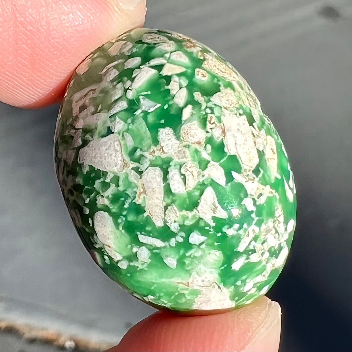 A loose green variscite cabochon from Utah, USA.