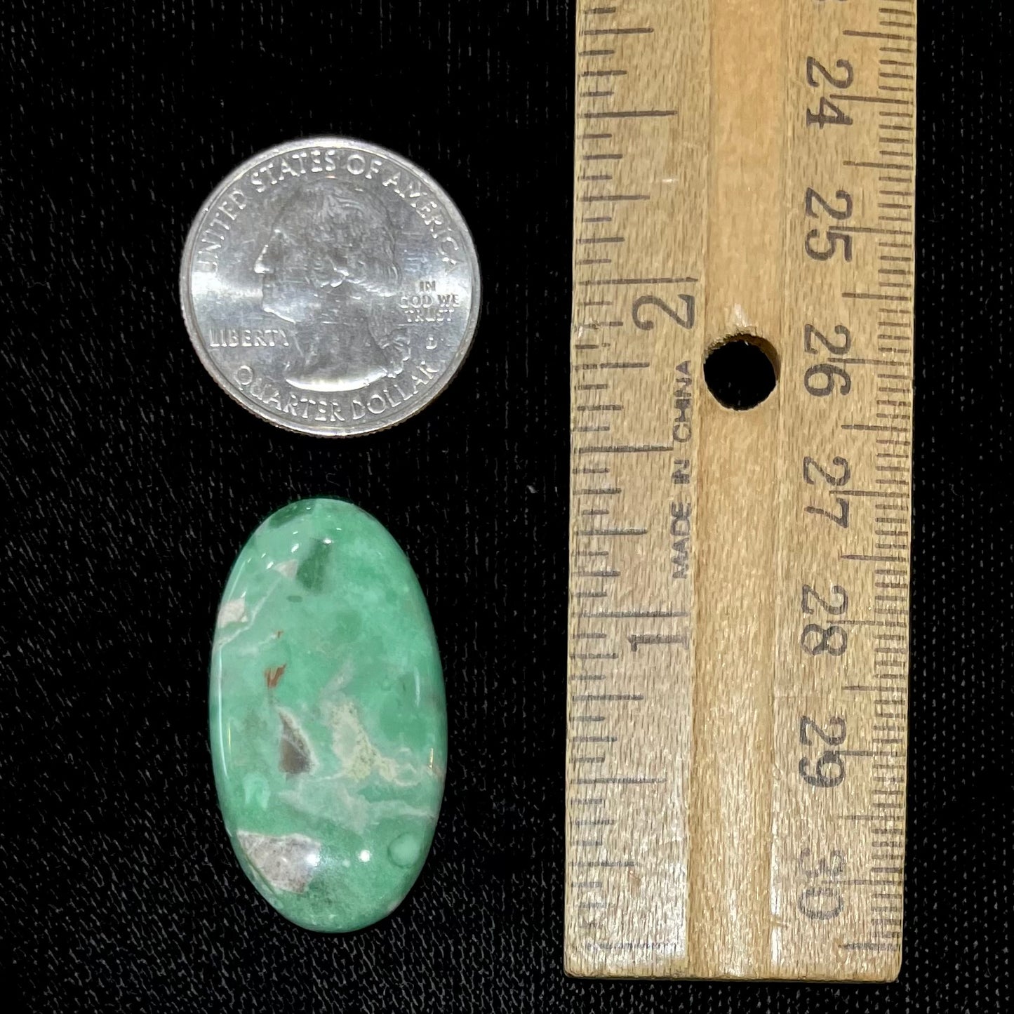 A loose, oval cabochon cut variscite stone from Utah, USA.