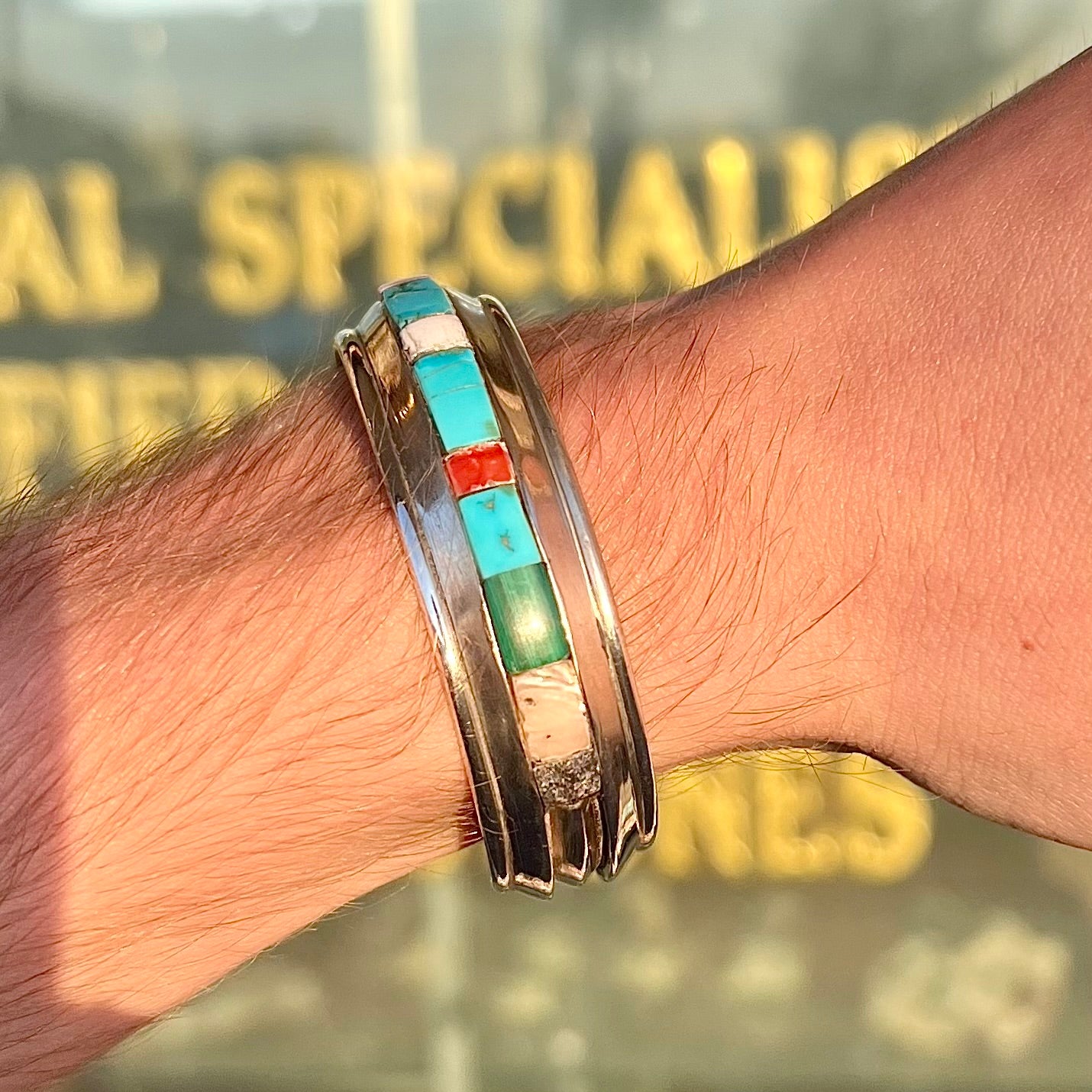 A vintage sterling silver stone inlay cuff bracelet, signed "AHASTEEN" by the Navajo artsit.