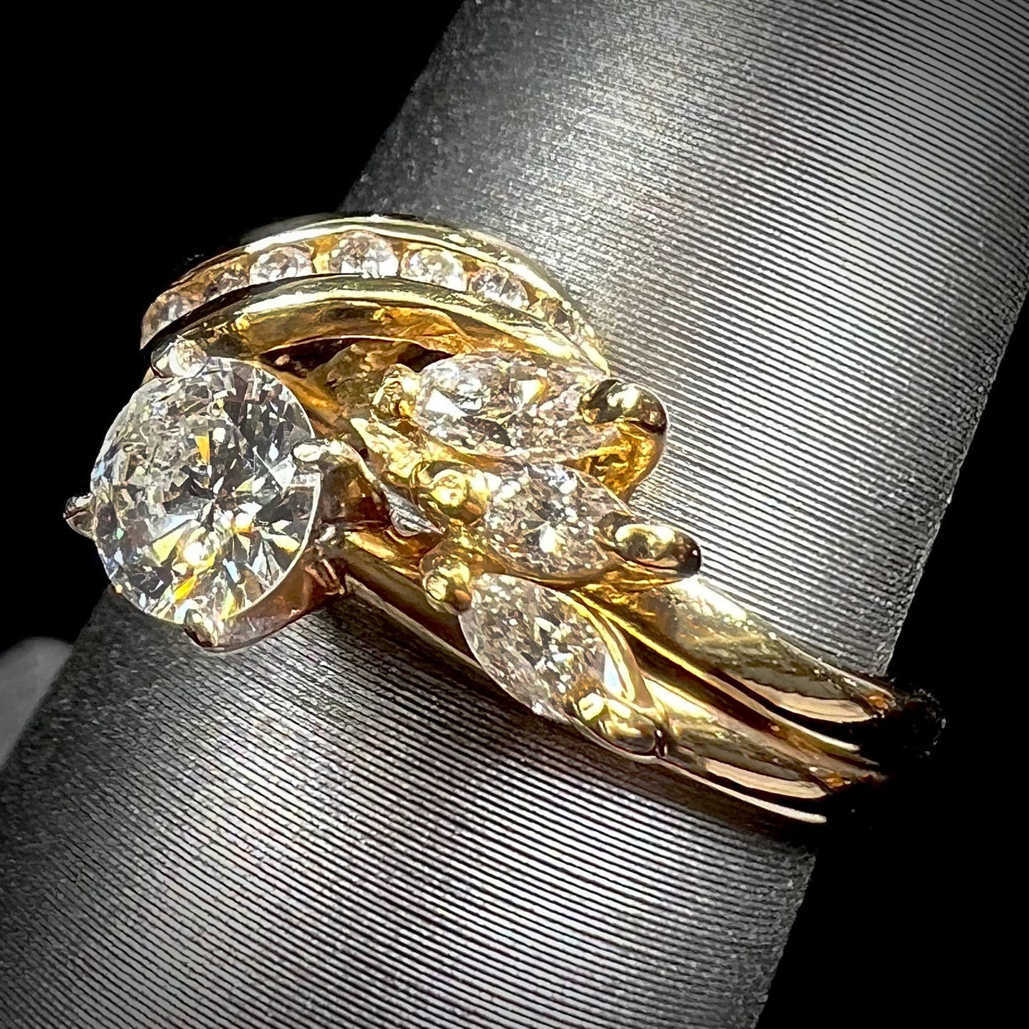 A ladies' diamond wedding set that has been soldered together in yellow gold. There are round and marquise cut diamonds.