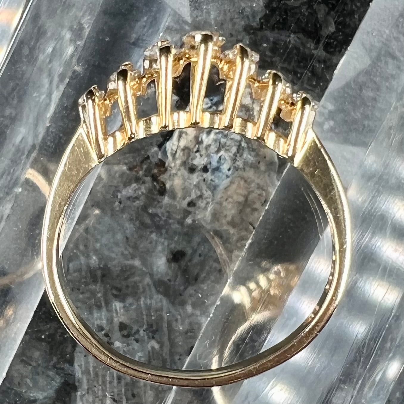 An estate yellow gold ring prong set with seven marquise cut diamonds.