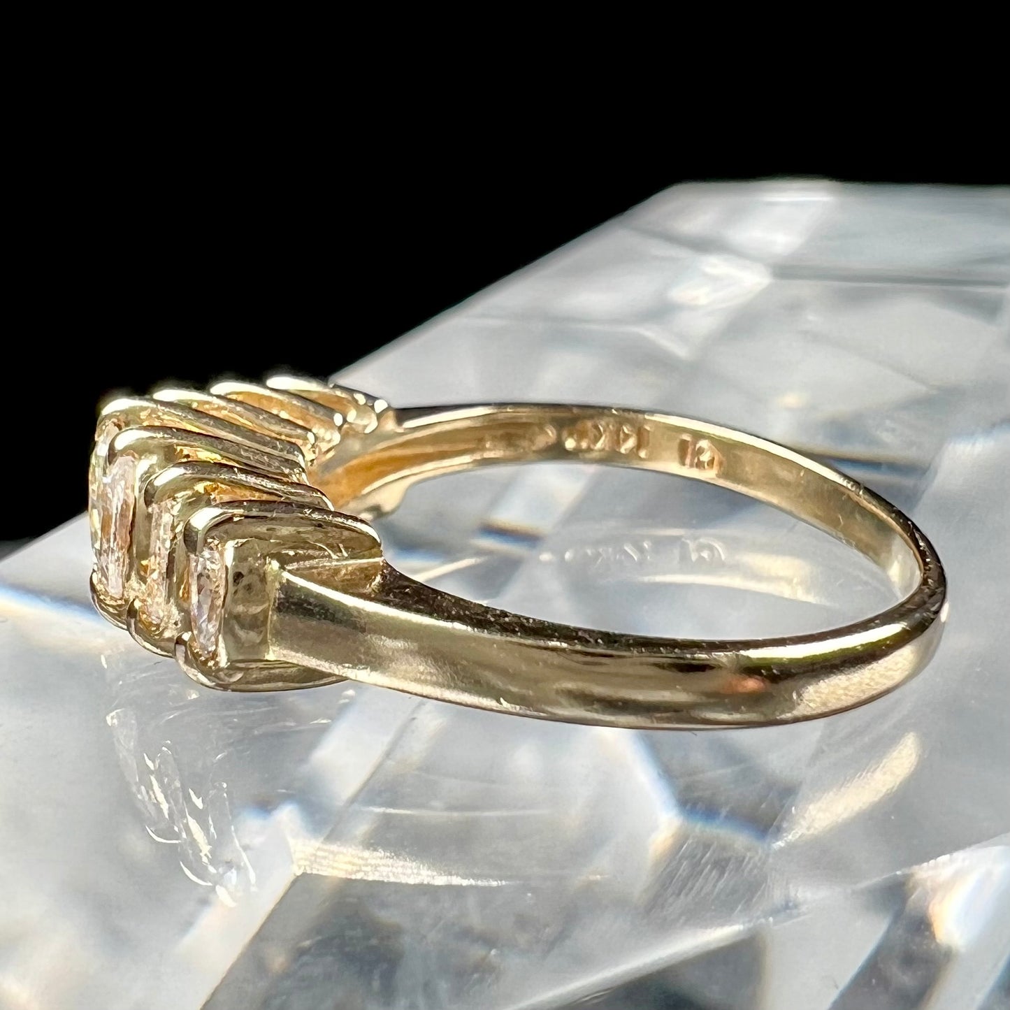 An estate yellow gold ring prong set with seven marquise cut diamonds.