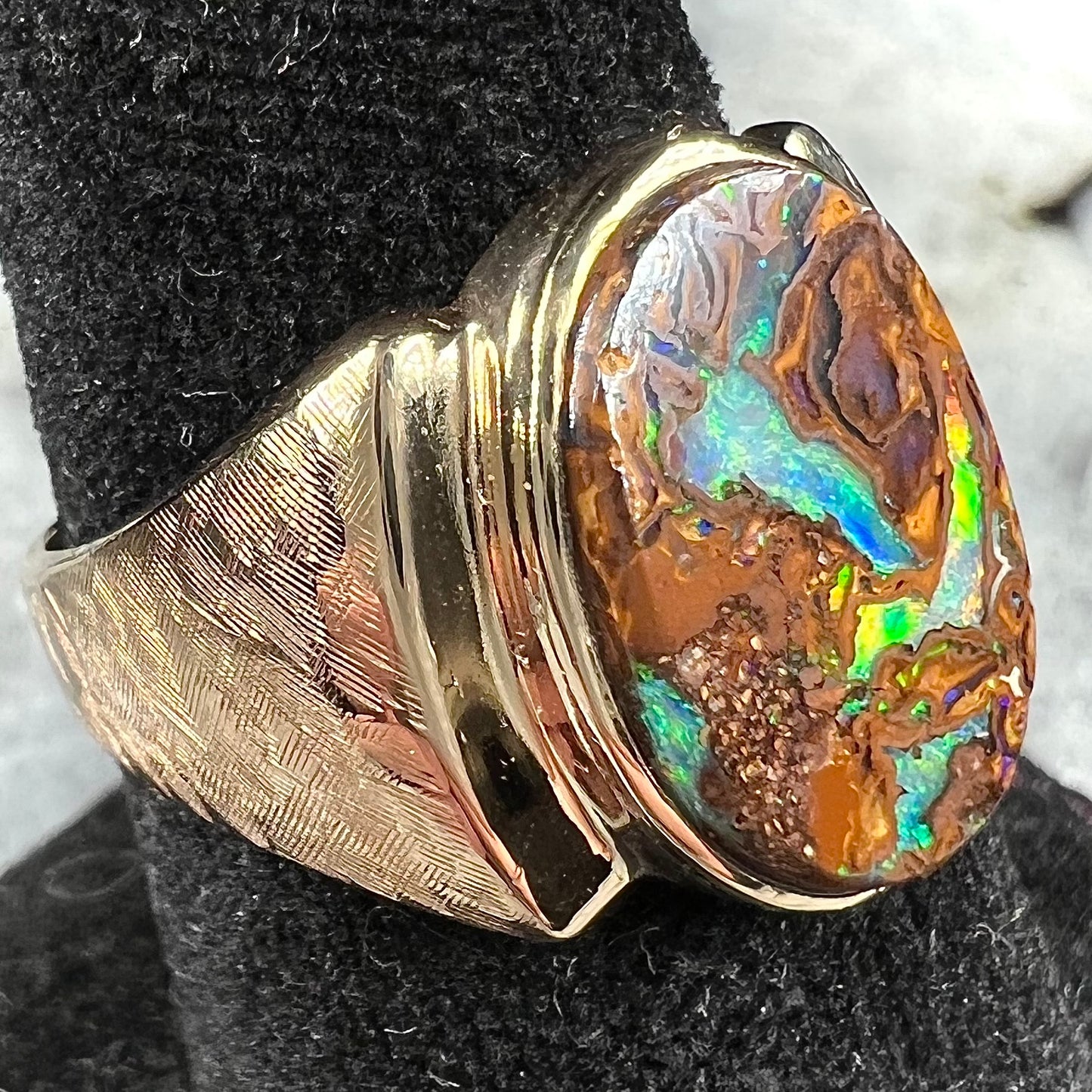 A Koroit boulder opal men's ring in brushed yellow gold.