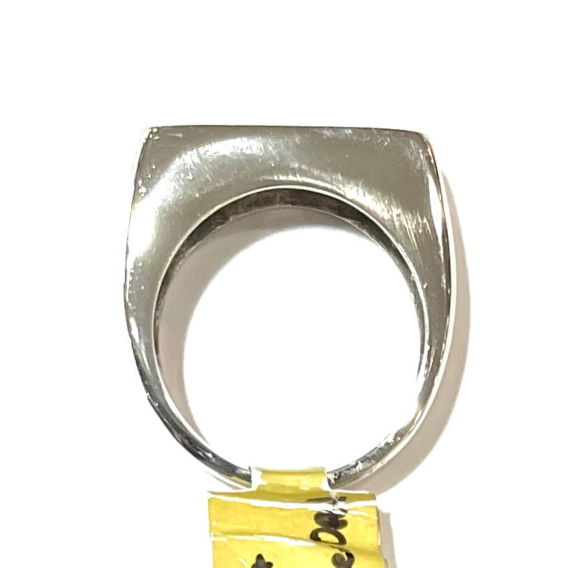 A white gold flush set boulder opal solitaire ring. The style is unisex.