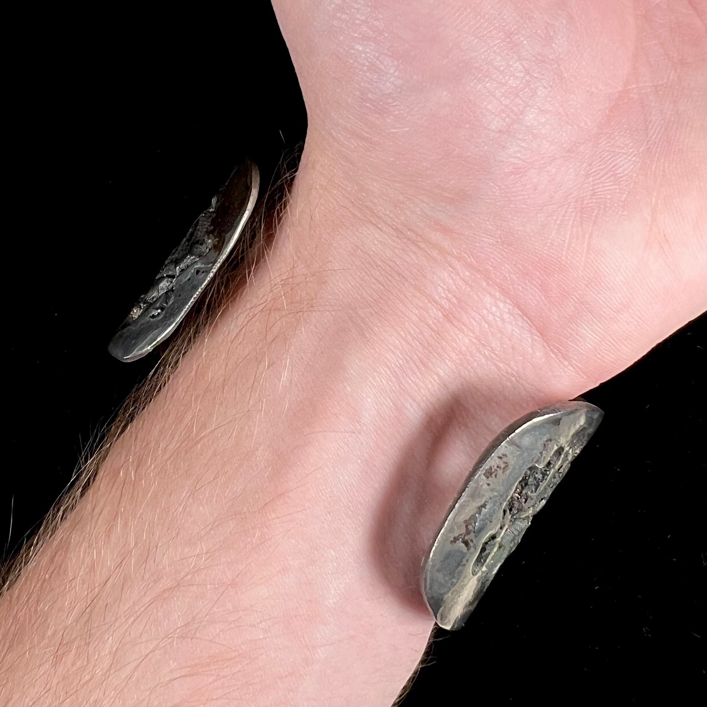 A men's sterling silver and copper infused cuff bracelet set with two boulder opal stones from Koroit, Australia.