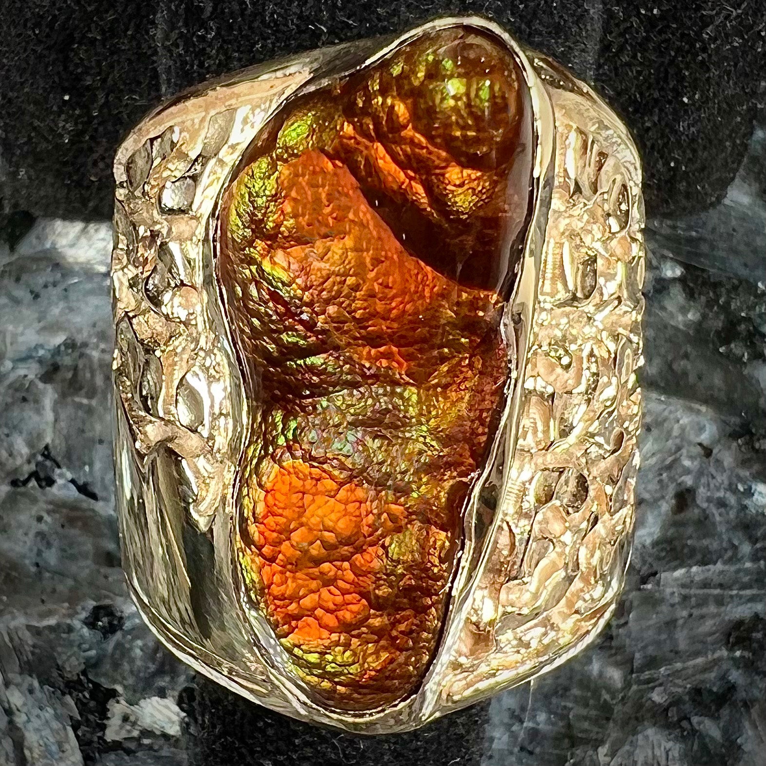 A large nugget style men's fire agate ring cast in yellow gold.  The fire agate is predominantly orange and green.