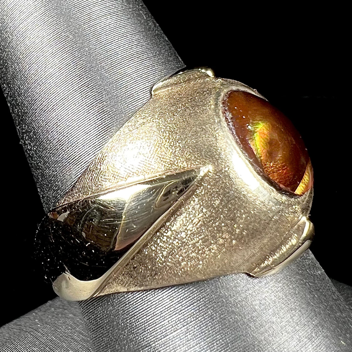 A men's brushed yellow gold fire agate ring with polished accents.