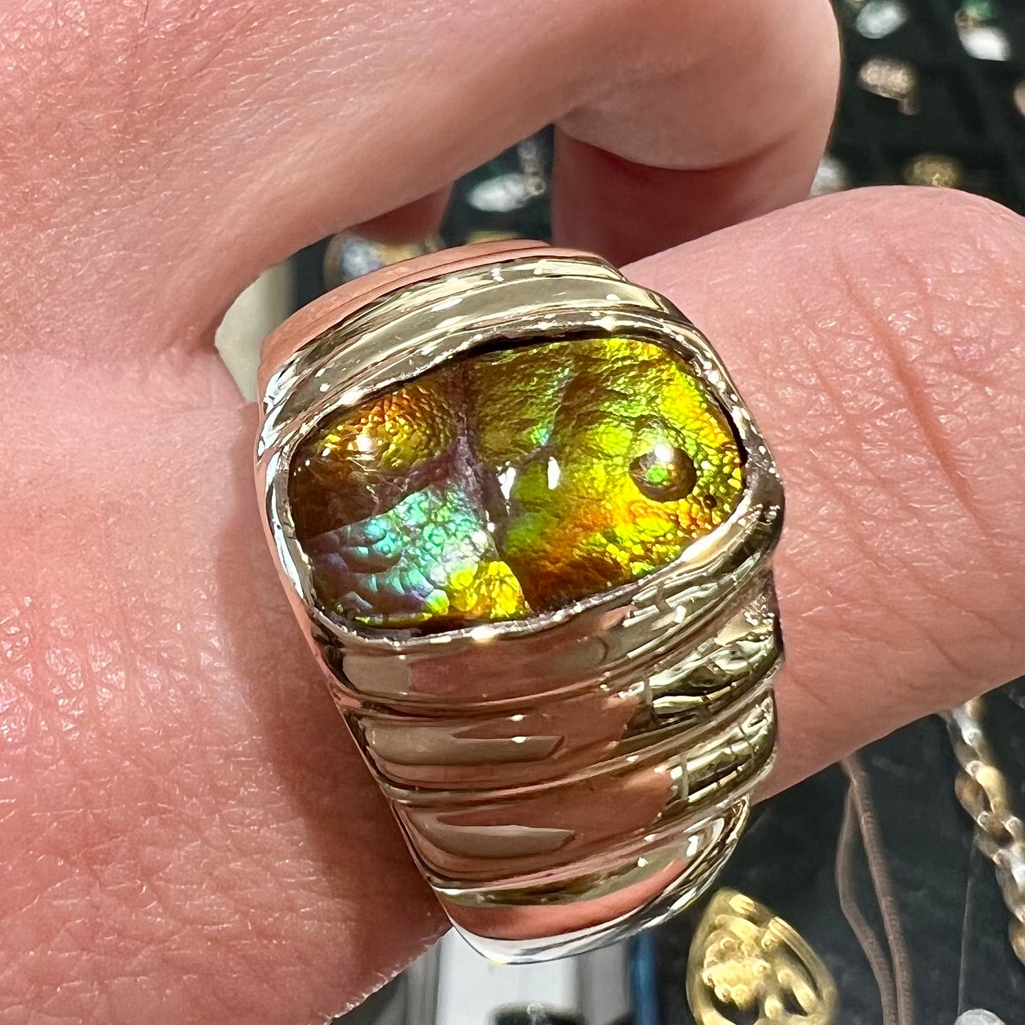 Men's fire agate solitaire ring cast in yellow gold. The ring is a step design.