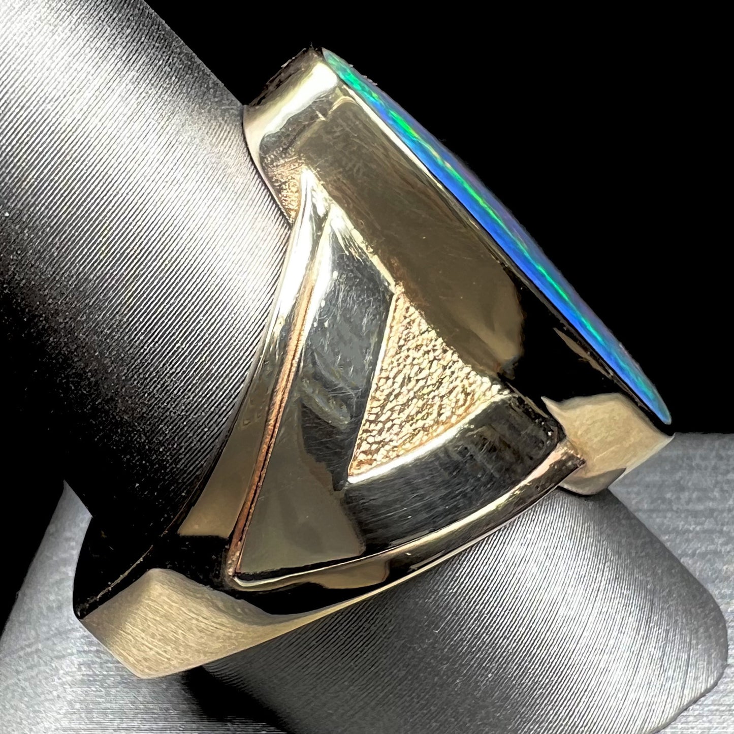 A men's two-tone gold solitaire ring set with a natural boulder opal from Koroit Mining District, Australia.