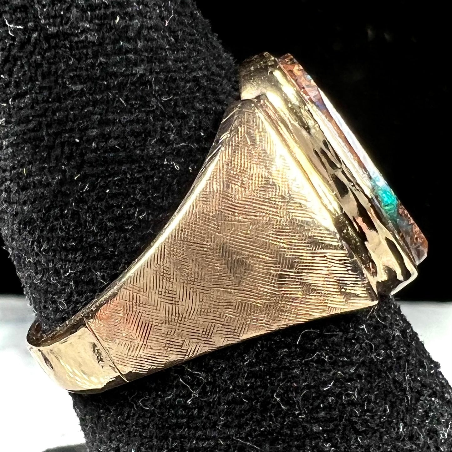 A Koroit boulder opal men's ring in brushed yellow gold.