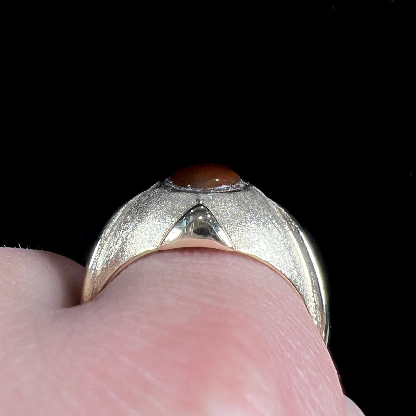 A men's brushed yellow gold fire agate ring with polished accents.
