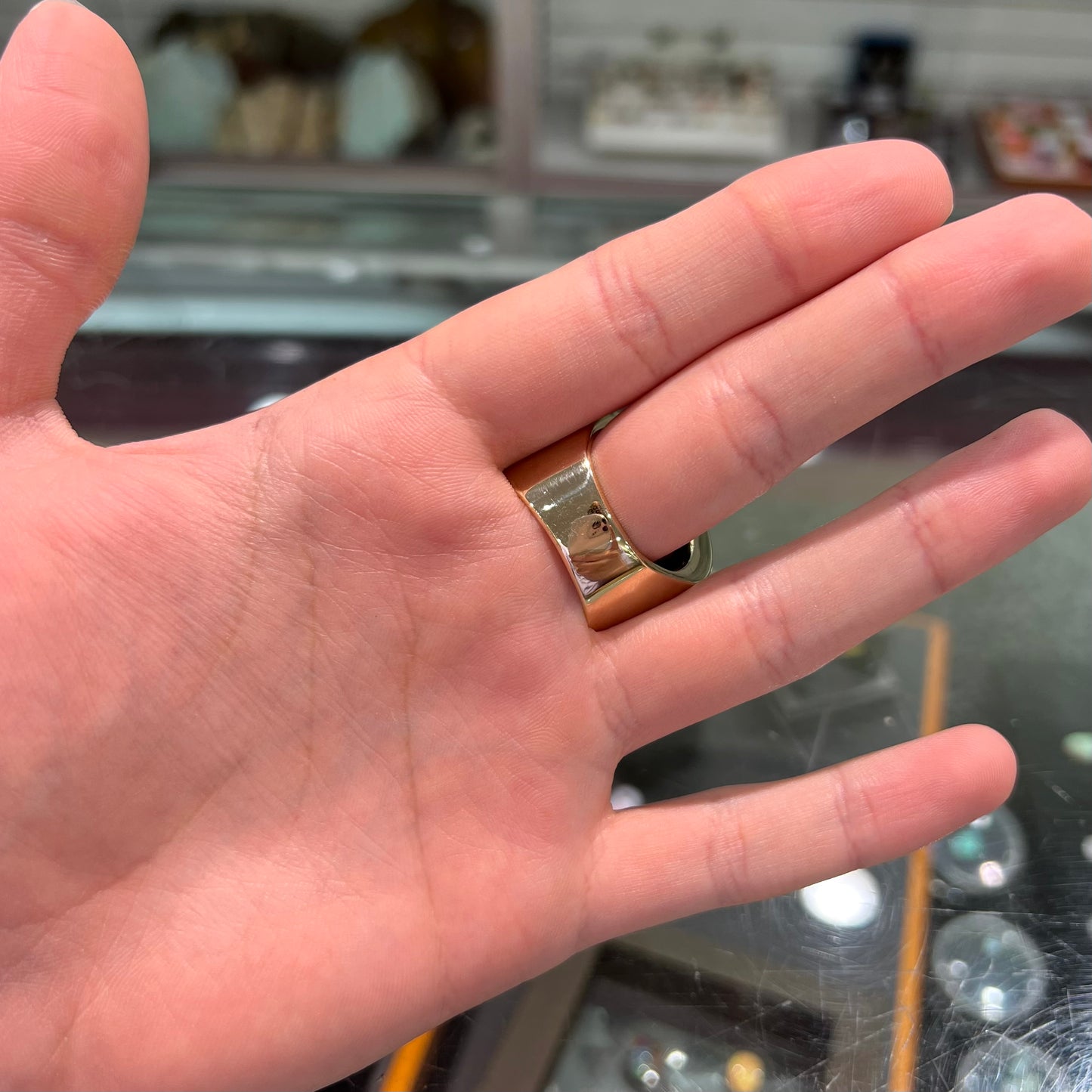 A large nugget style men's fire agate ring cast in yellow gold.  The fire agate is predominantly orange and green.