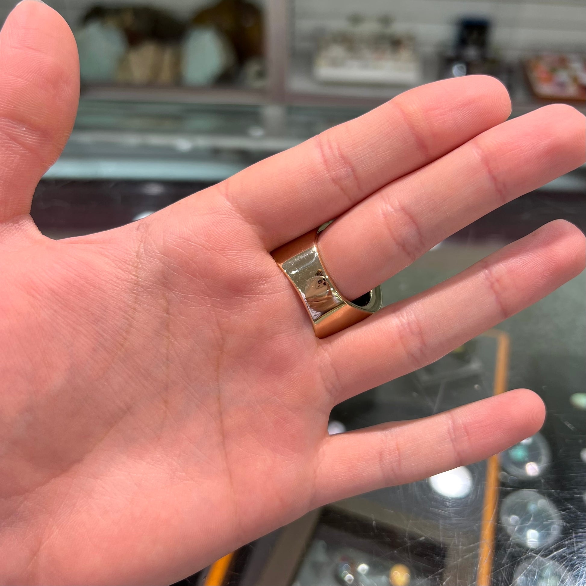 A large nugget style men's fire agate ring cast in yellow gold.  The fire agate is predominantly orange and green.