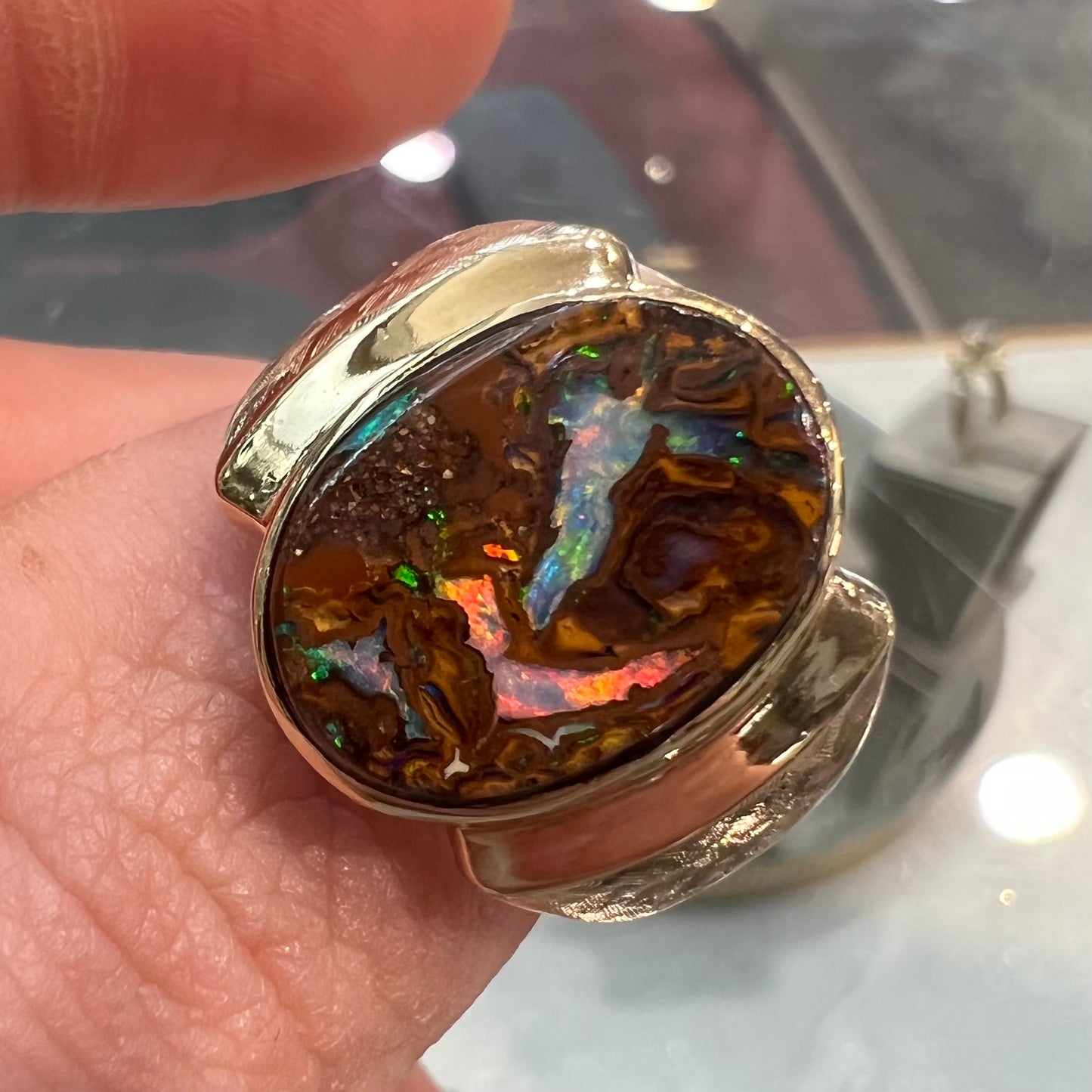 A Koroit boulder opal men's ring in brushed yellow gold.