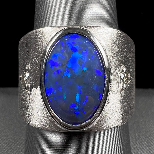 A men's natural black opal and diamond ring cast with a matte finish in white gold.