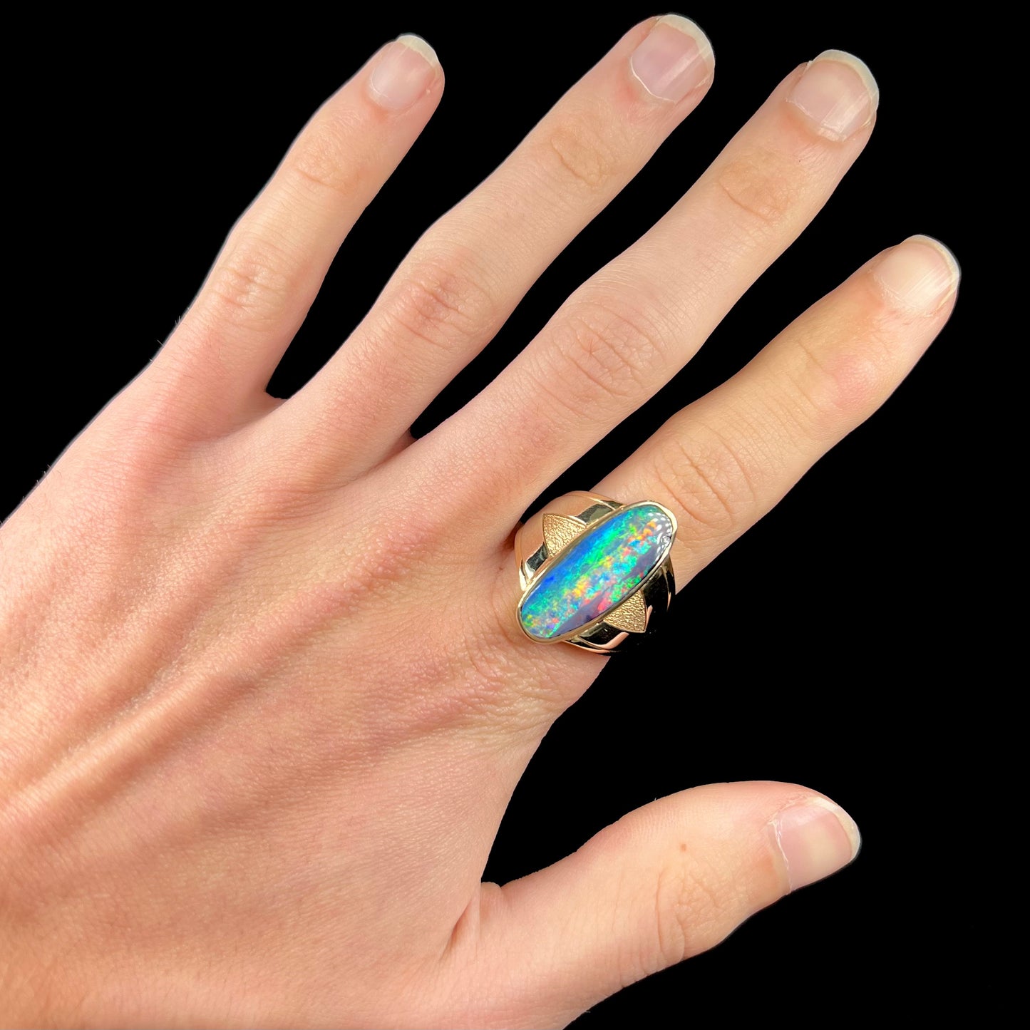 A men's two-tone gold solitaire ring set with a natural boulder opal from Koroit Mining District, Australia.