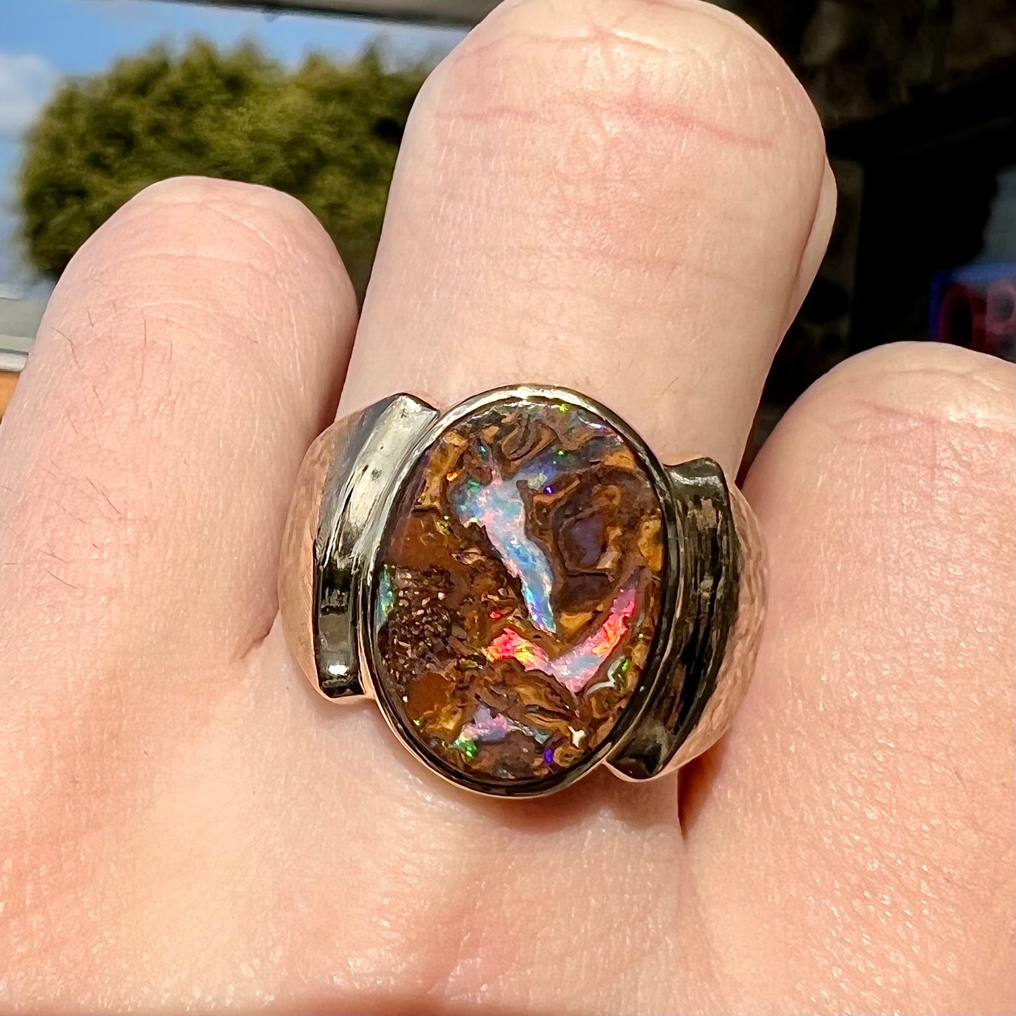 A Koroit boulder opal men's ring in brushed yellow gold.