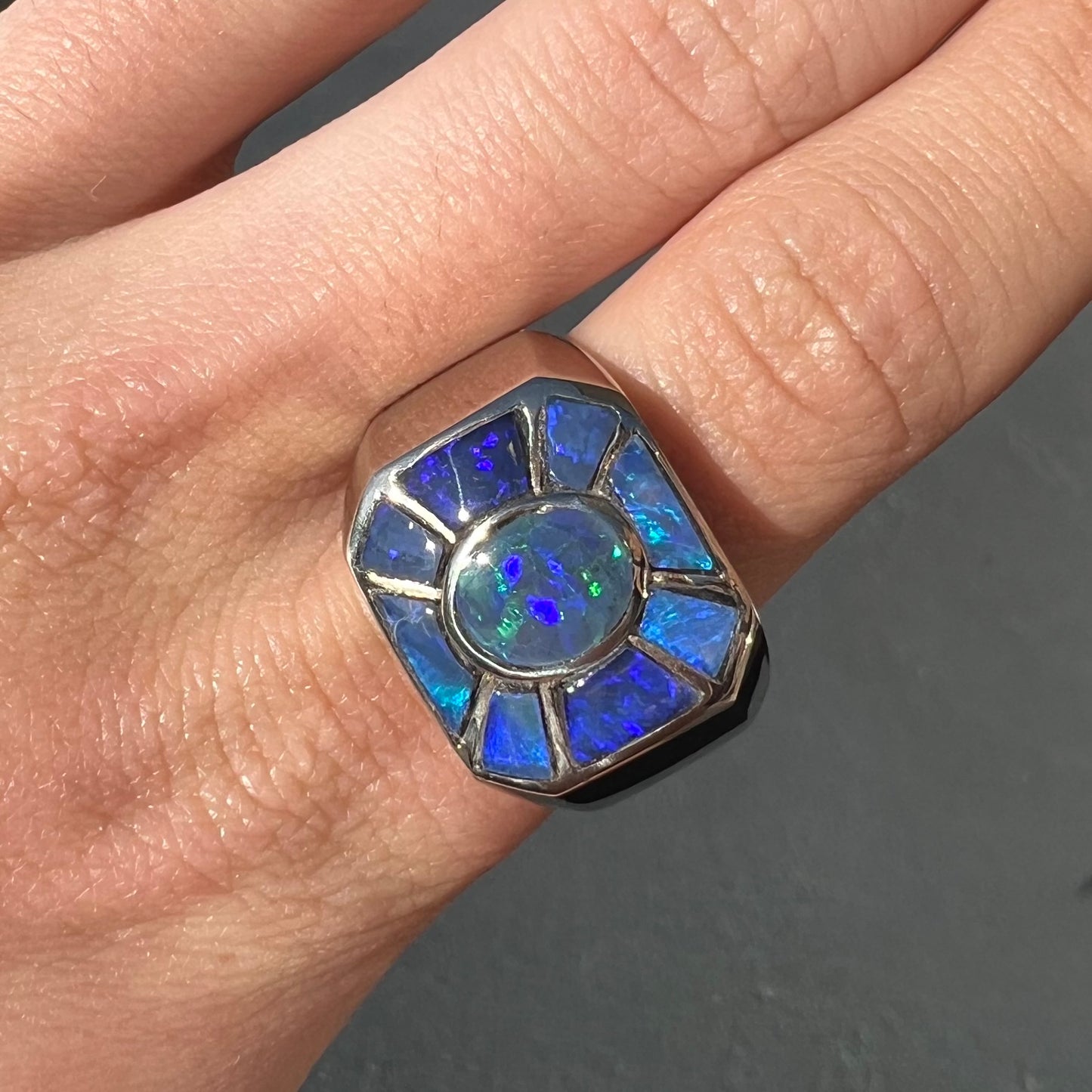 A men's white gold ring inlay set with Lightning Ridge, Austalian black crystal opal.