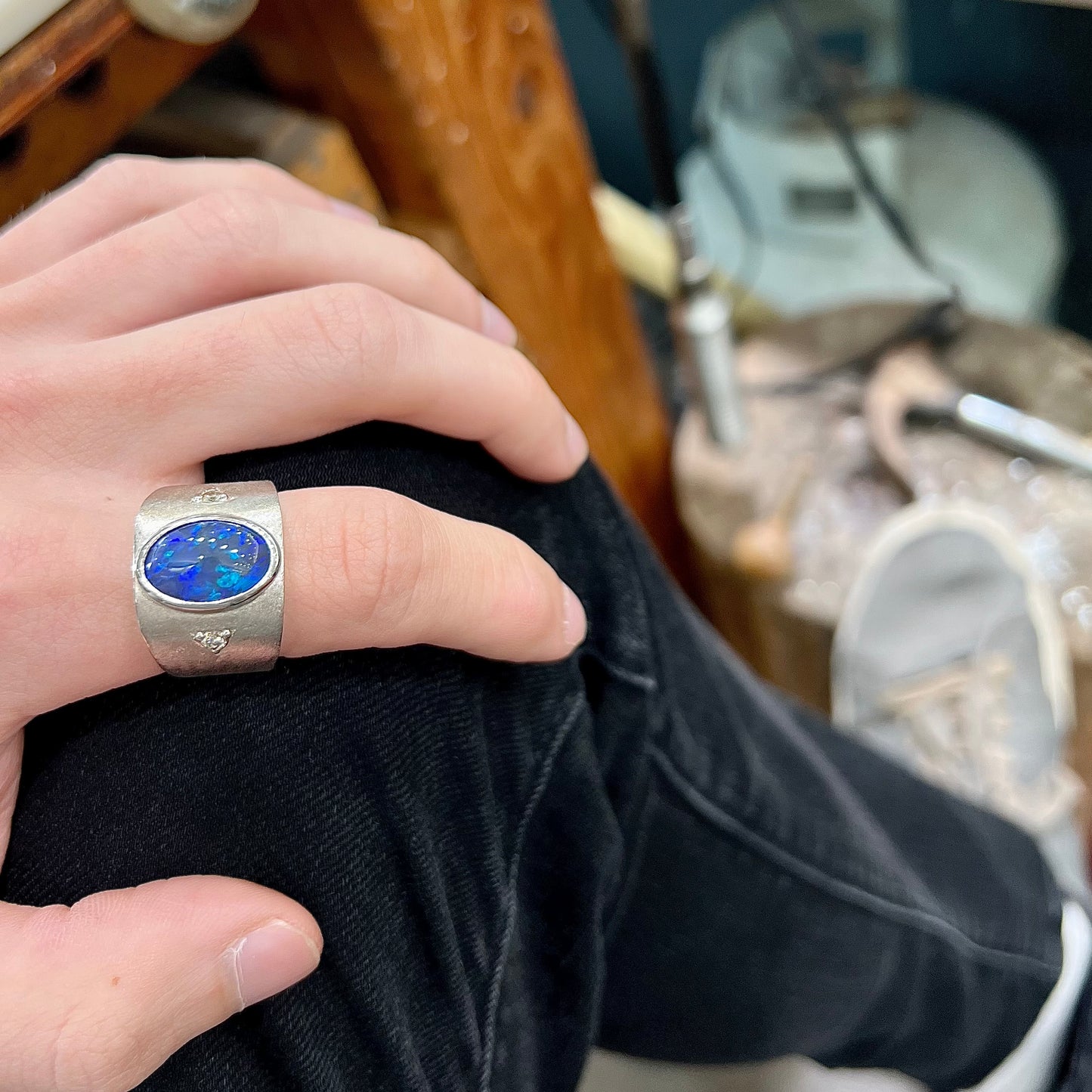 A men's natural black opal and diamond ring cast with a matte finish in white gold.