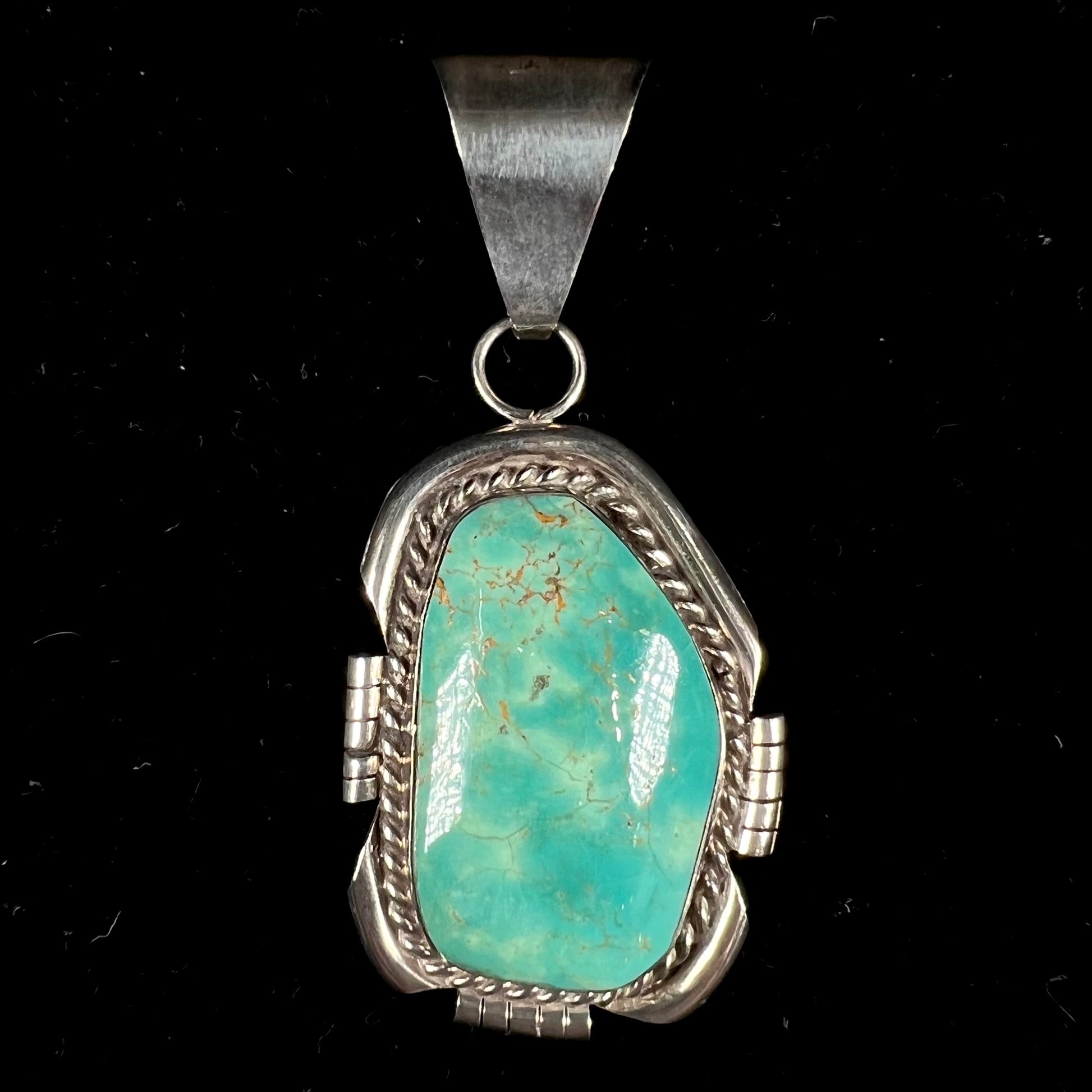 A men's silver Navajo pendant set with a turquoise stone from Pilot Mountain Mine, Nevada.