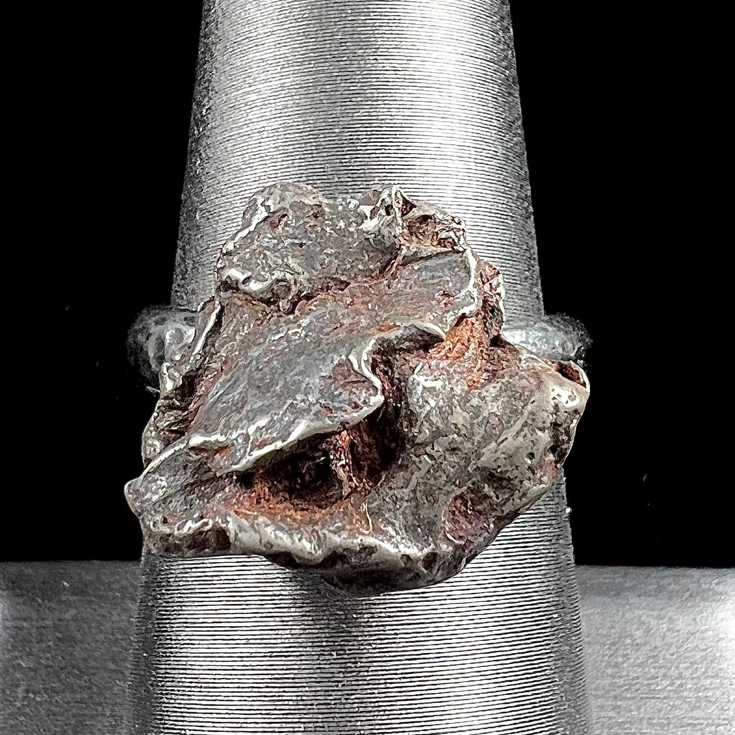 A sterling silver ring set with a Campo del Cielo meteorite.