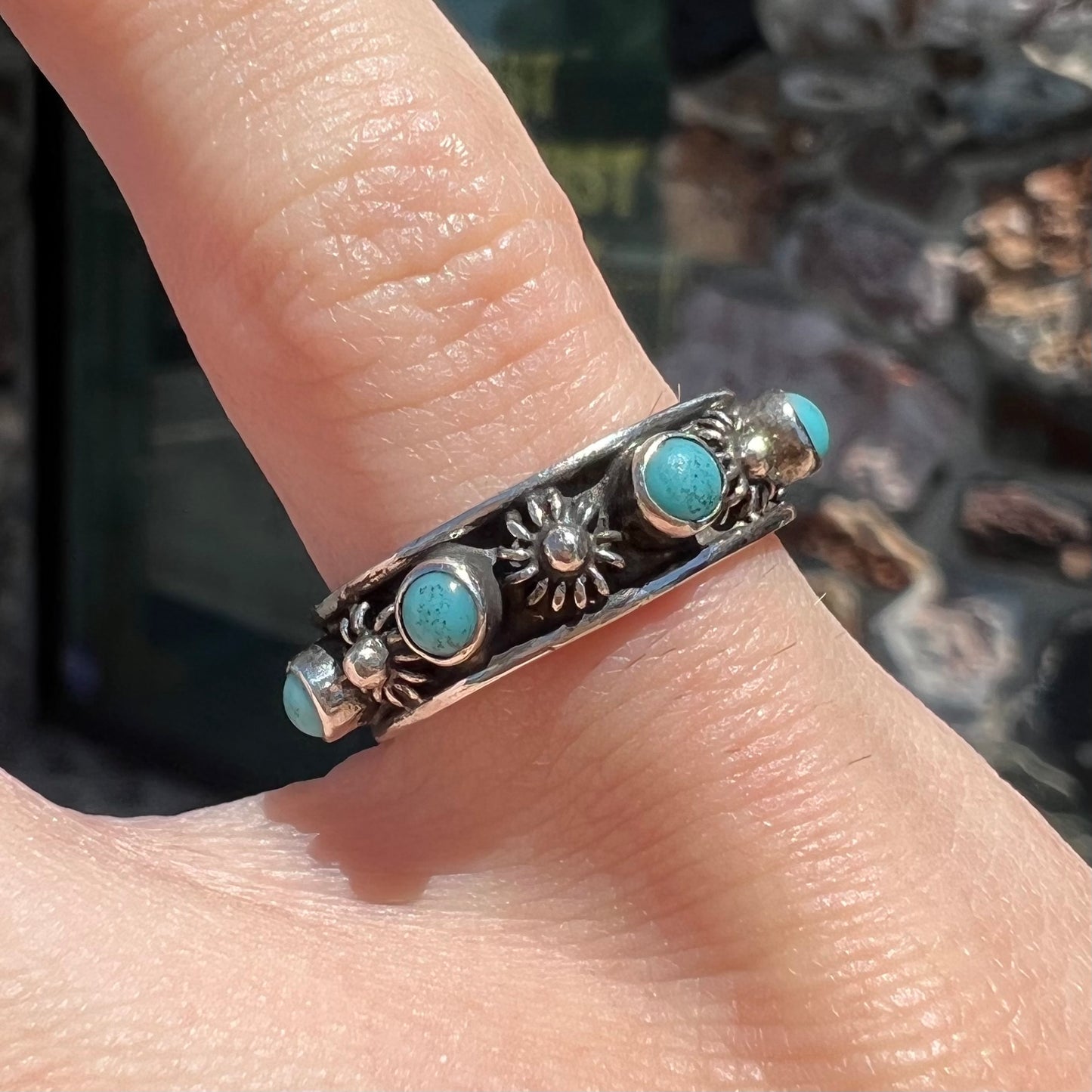 A sterling silver turquoise and flower design eternity band, made in Mexico.