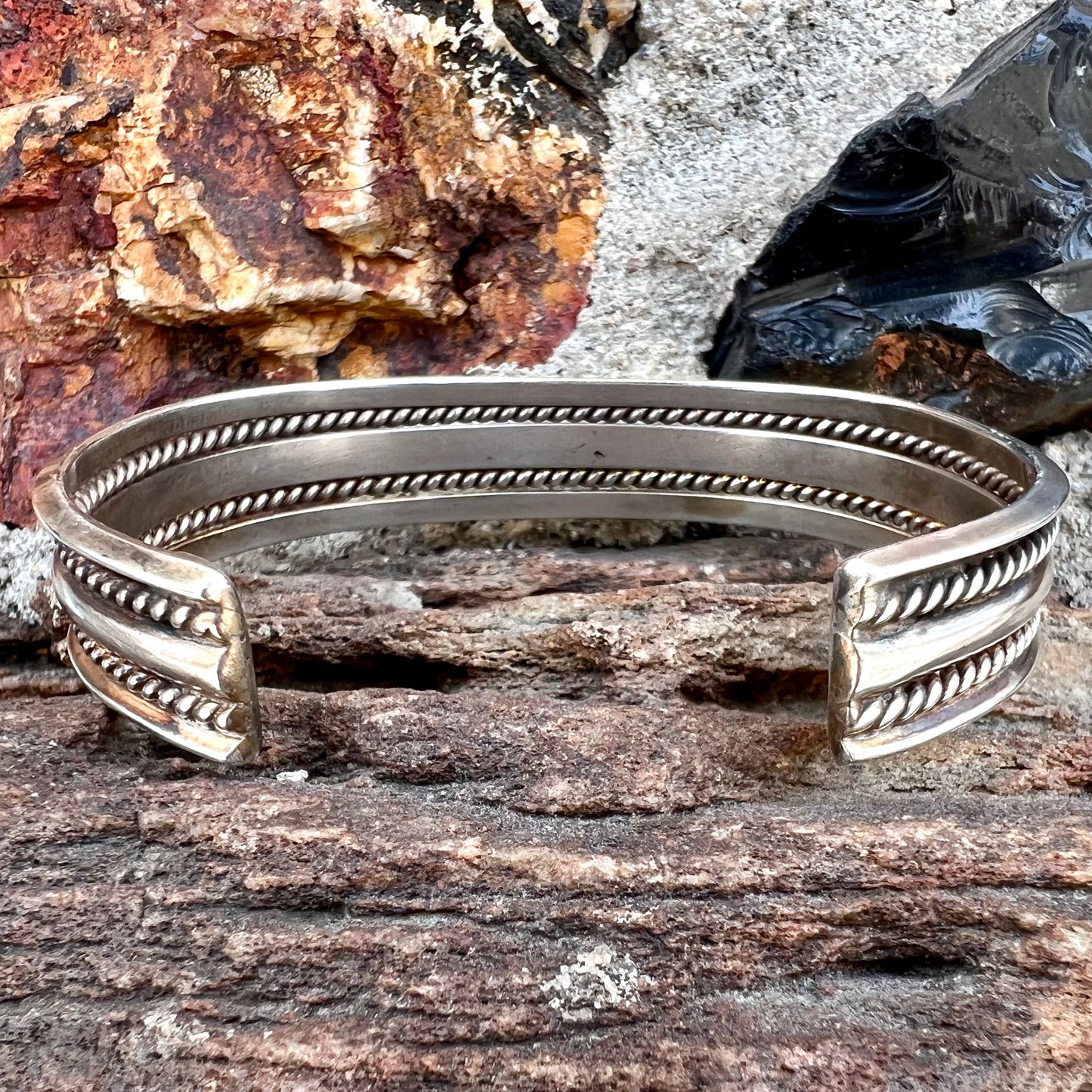 A handmade sterling silver cuff bracelet. The bracelet is made with a rope wire.