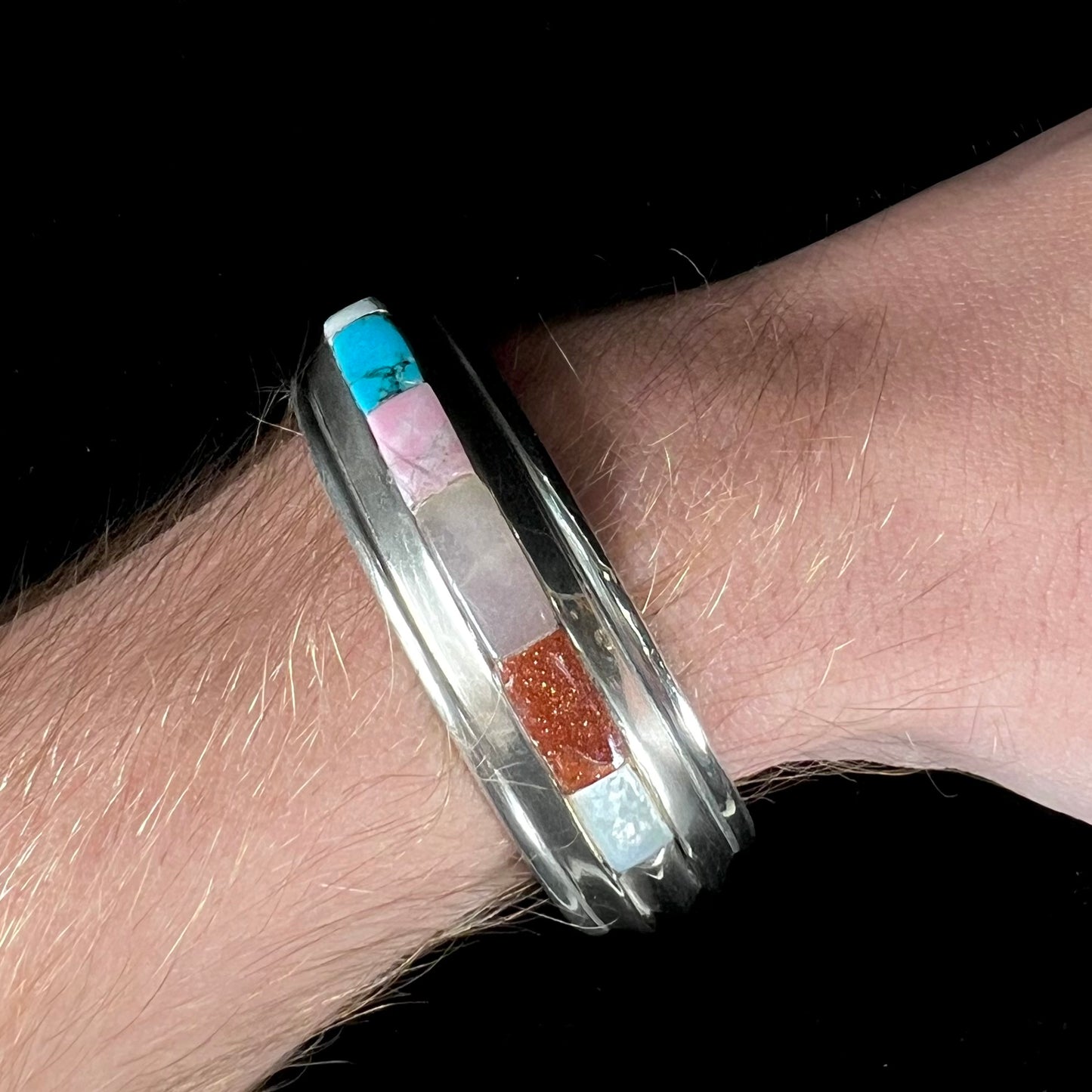 A vintage sterling silver stone inlay cuff bracelet, signed "AHASTEEN" by the Navajo artsit.