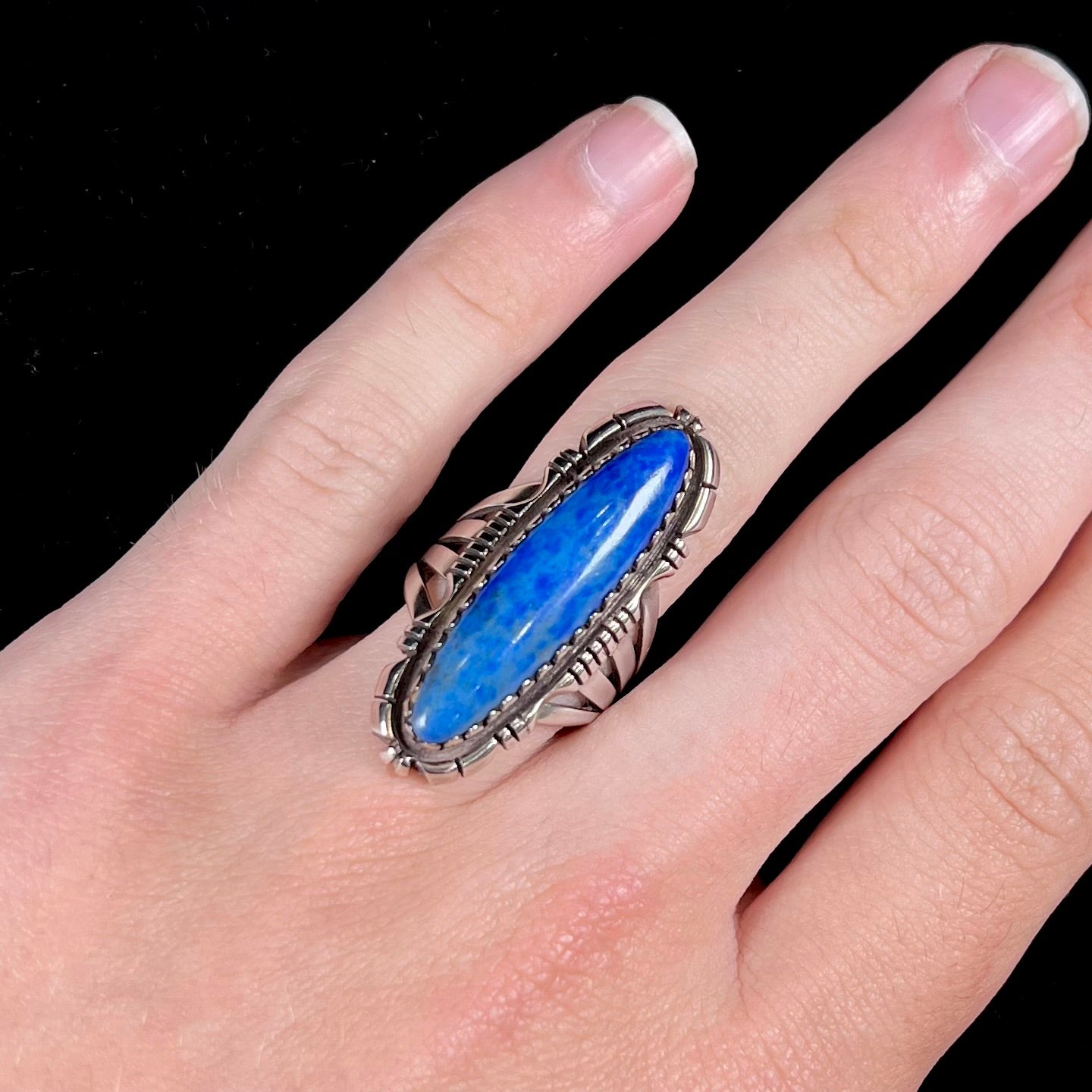 A Navajo style sterling silver lapis lazuli ring engraved with the words "R. Bennett".