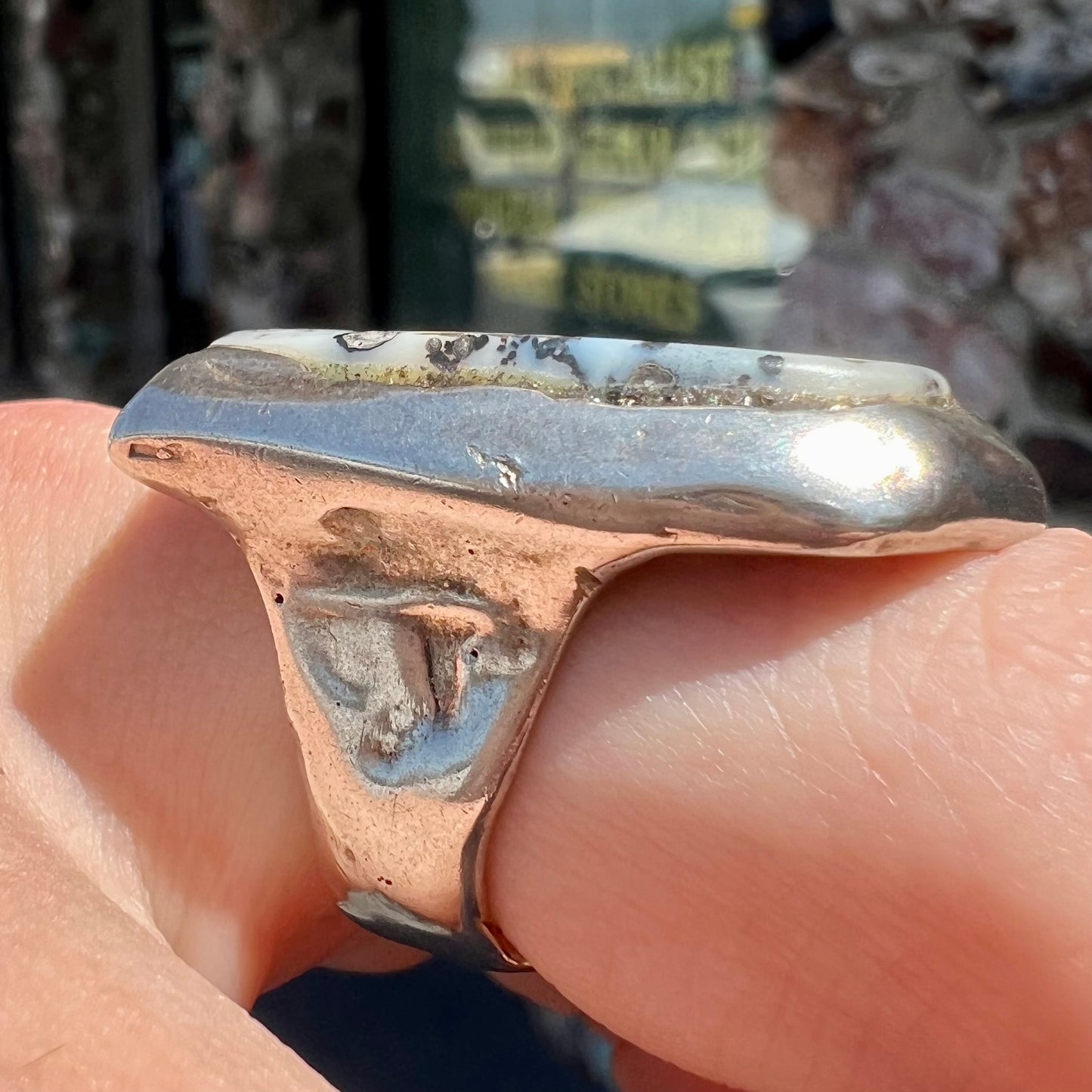 A bezel set ring handmade in sterling silver with a white dendritic agate stone.