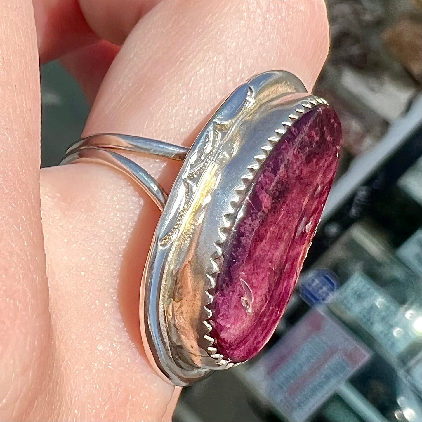 A sterling silver Navajo style ring set with a purple spiny oyster shell.