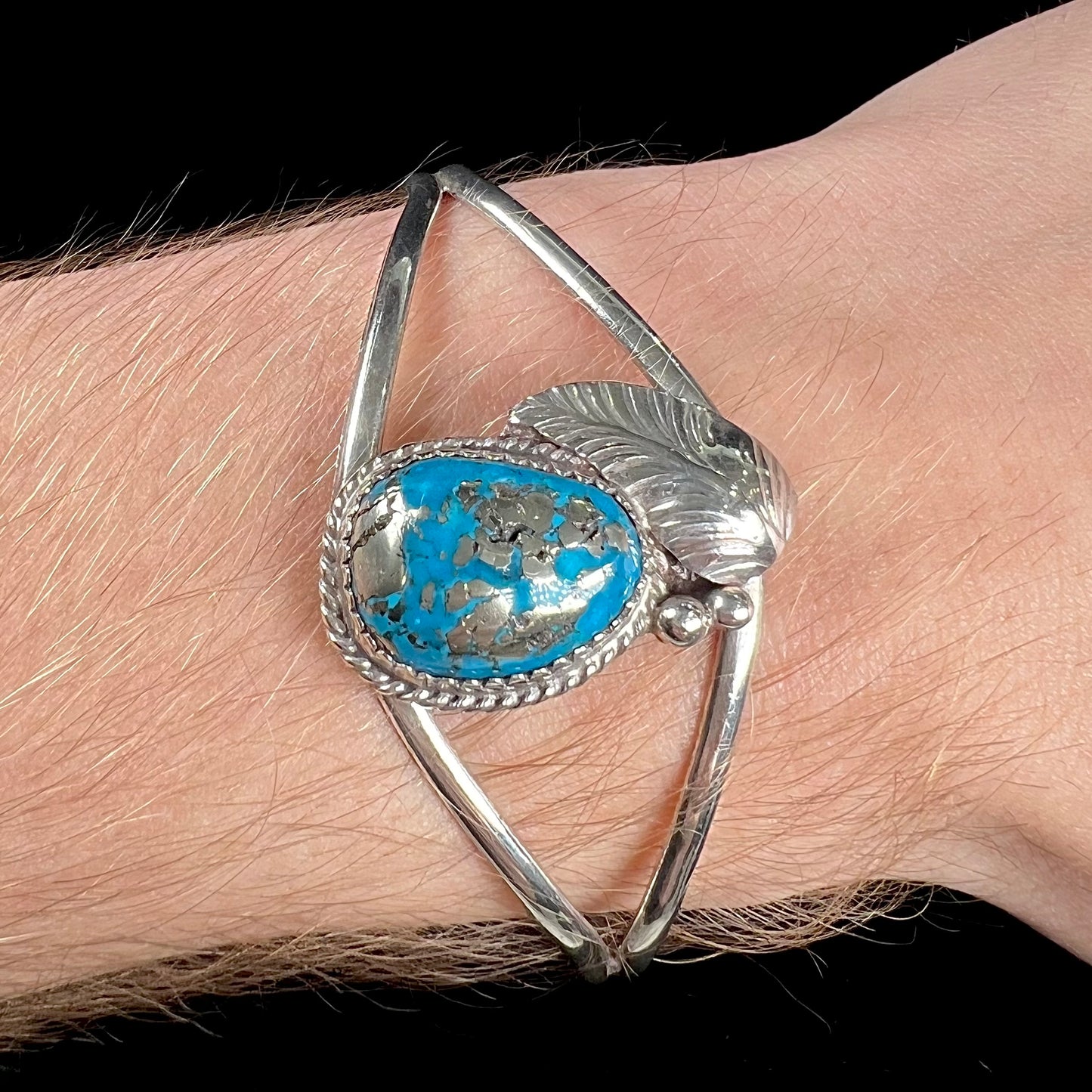 A ladies' silver Navajo cuff bracelet set with a piece of Morenci turquoise stone.