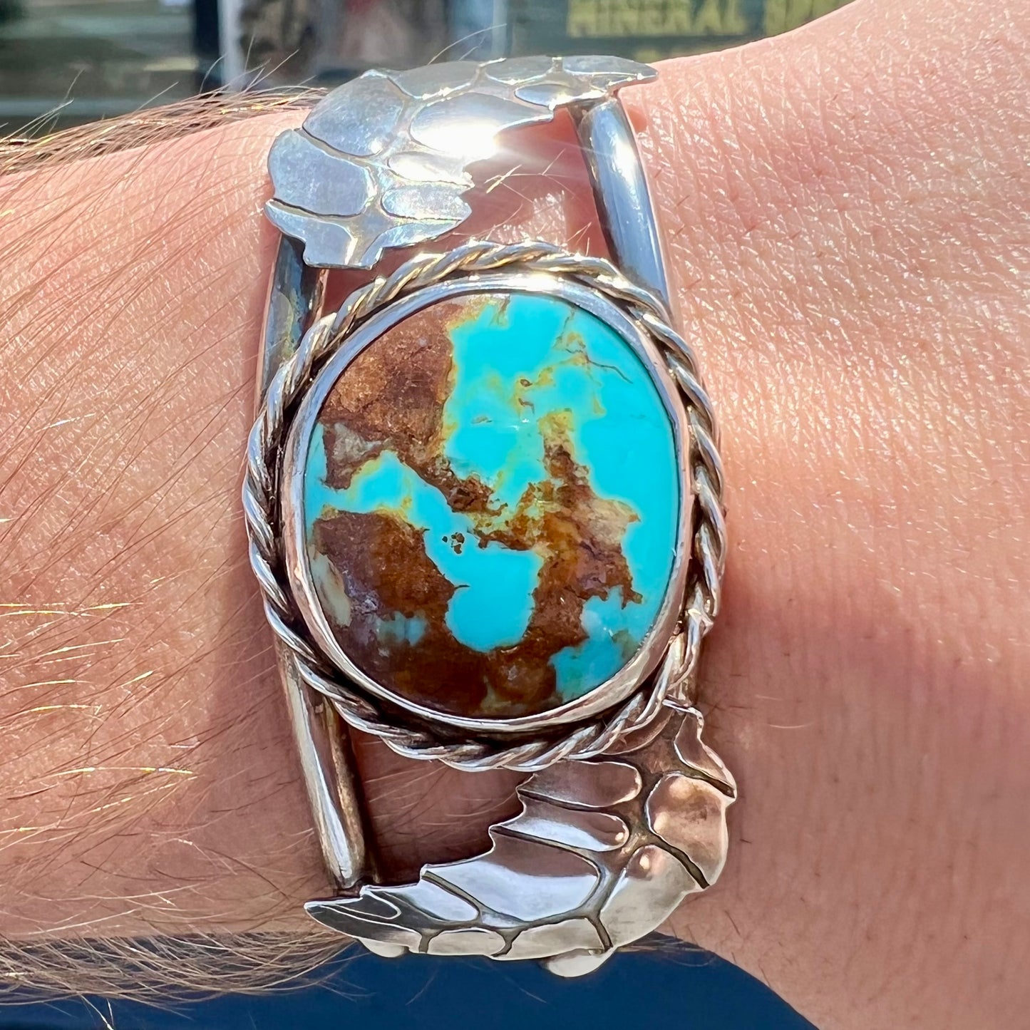 A sterling silver Navajo cuff bracelet set with a Royston turquoise stone.