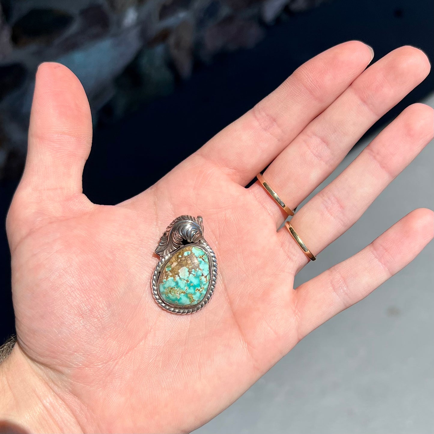A handmade silver Navajo style pendant set with a turquoise stone from Kingman, Arizona.