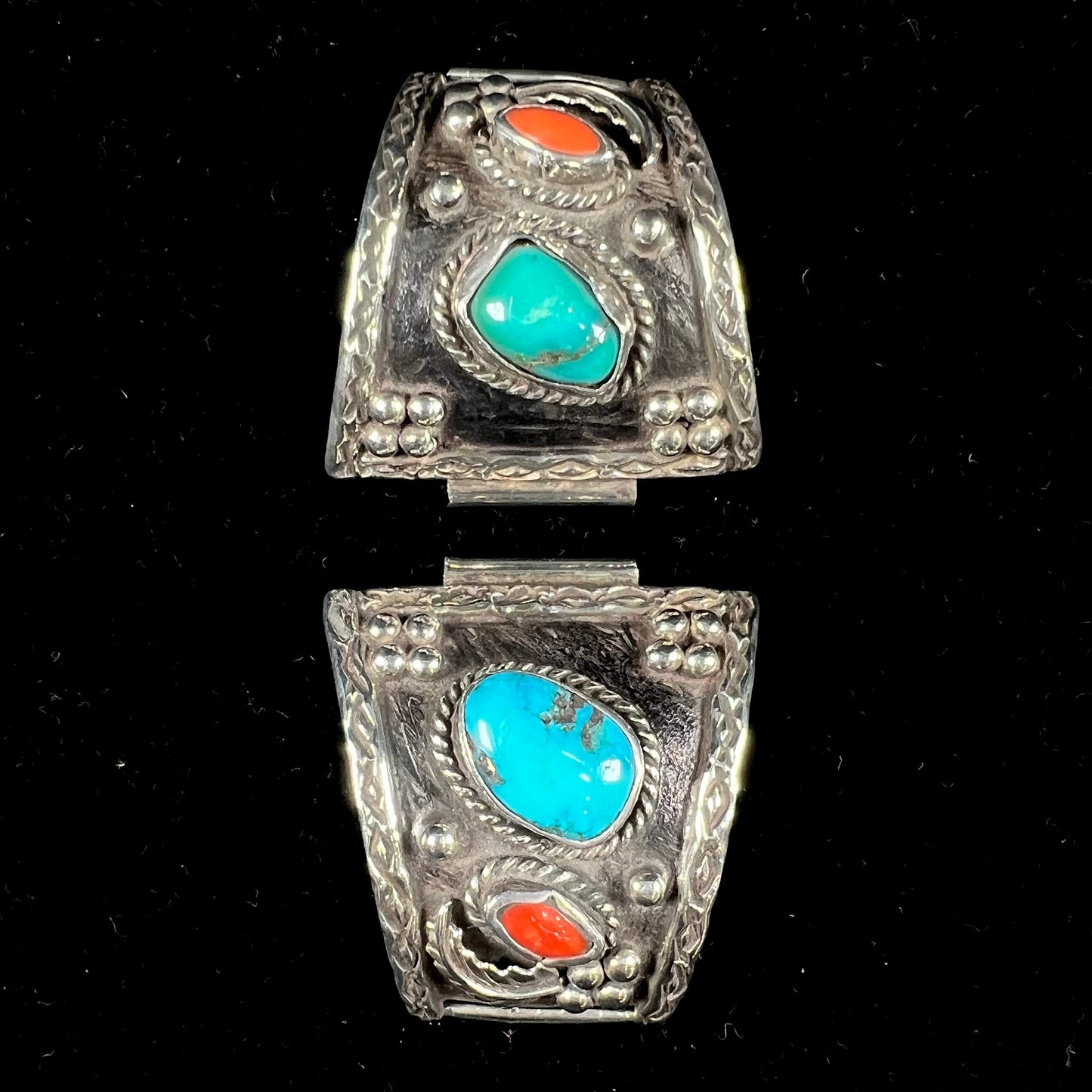 A pair of Navajo made sterling silver watch cuffs set with turquoise and coral stones.