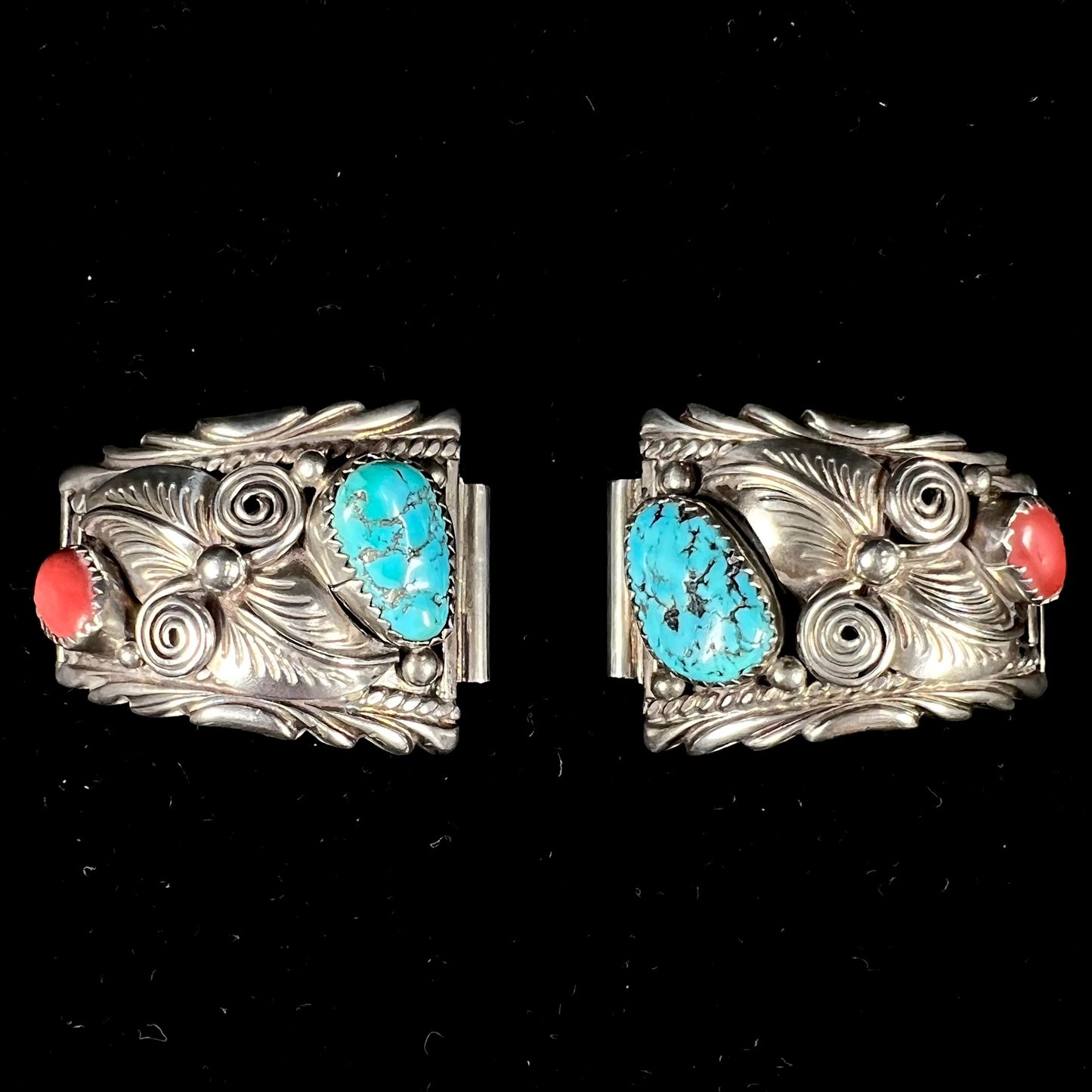 A pair of sterling silver watch cuffs set with turquoise and coral stones.
