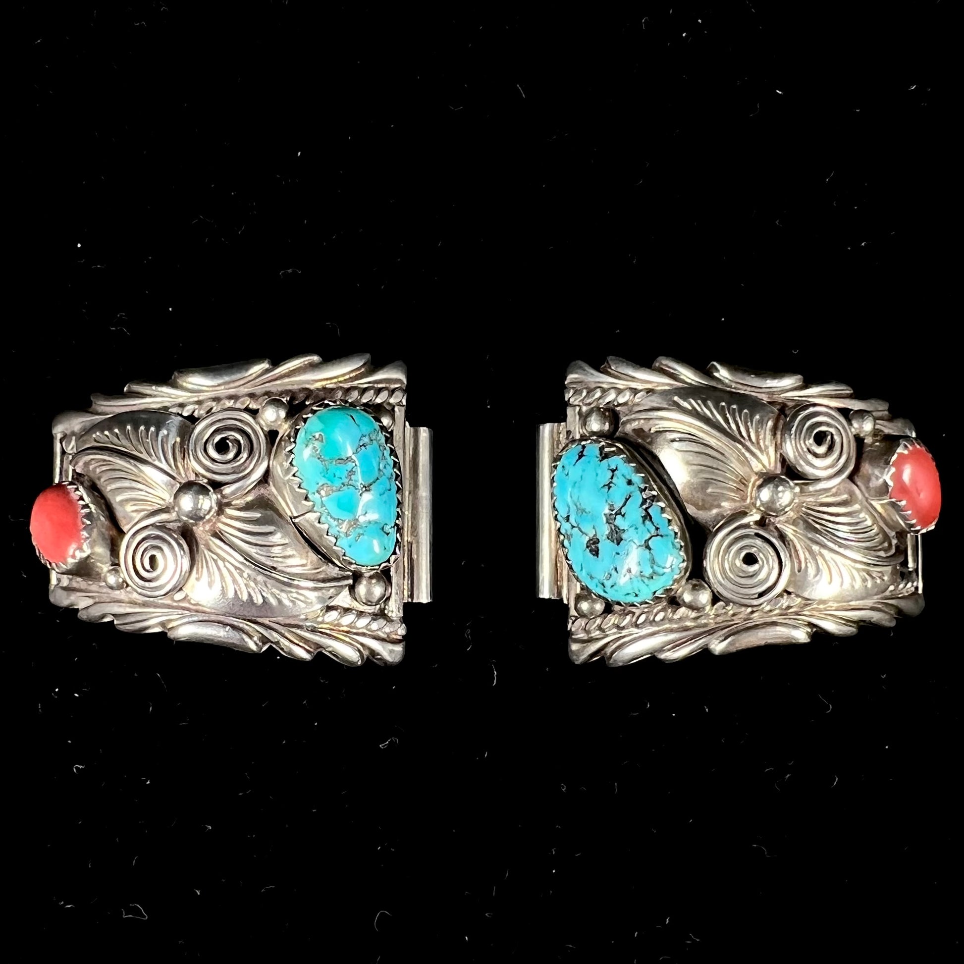 A pair of sterling silver watch cuffs set with turquoise and coral stones.