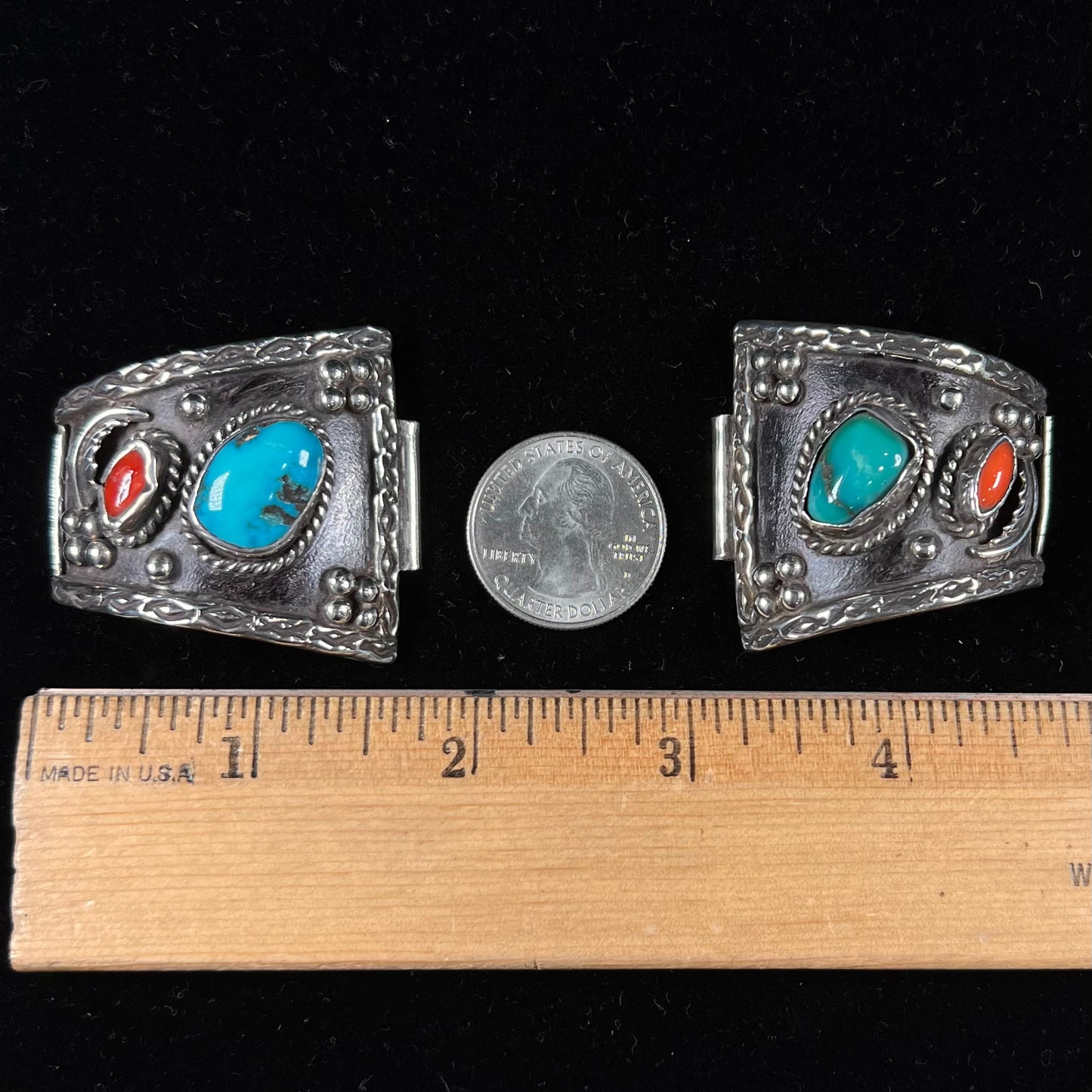 A pair of Navajo made sterling silver watch cuffs set with turquoise and coral stones.