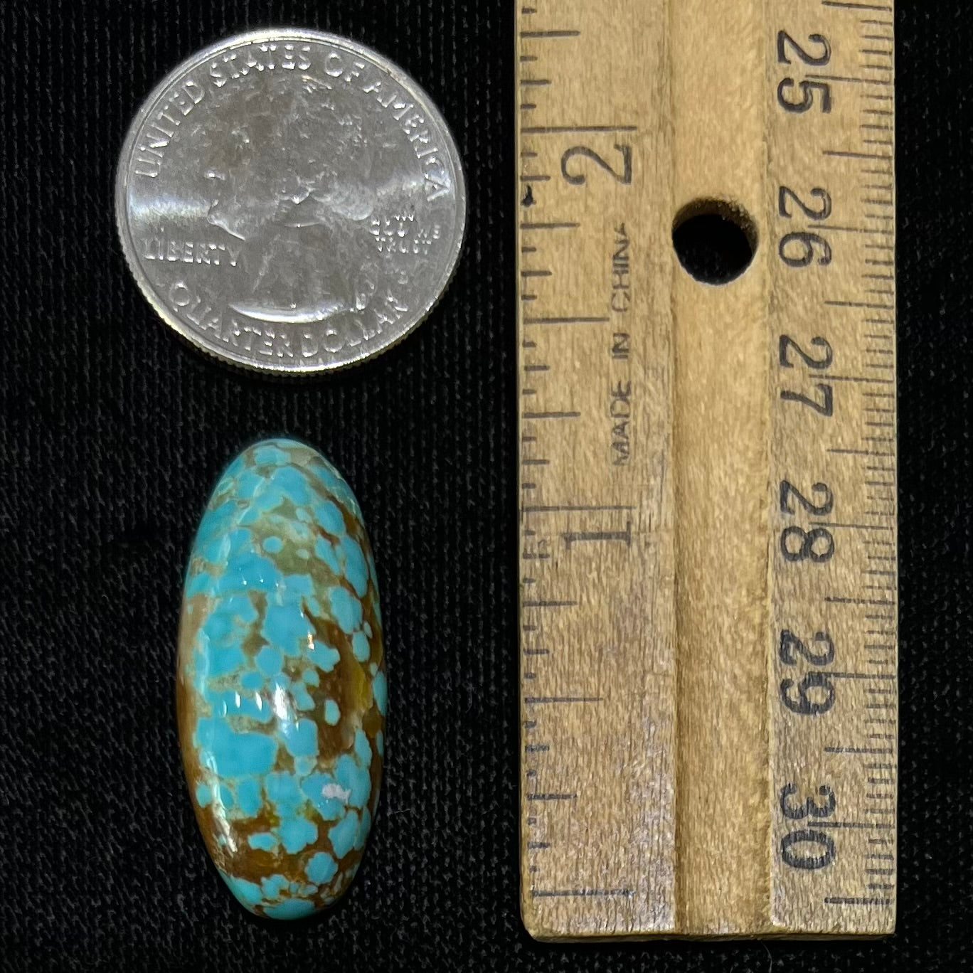 An oval cabochon cut loose turquoise stone from the Number 8 Mine in Nevada. Blue with chocolate matrix.