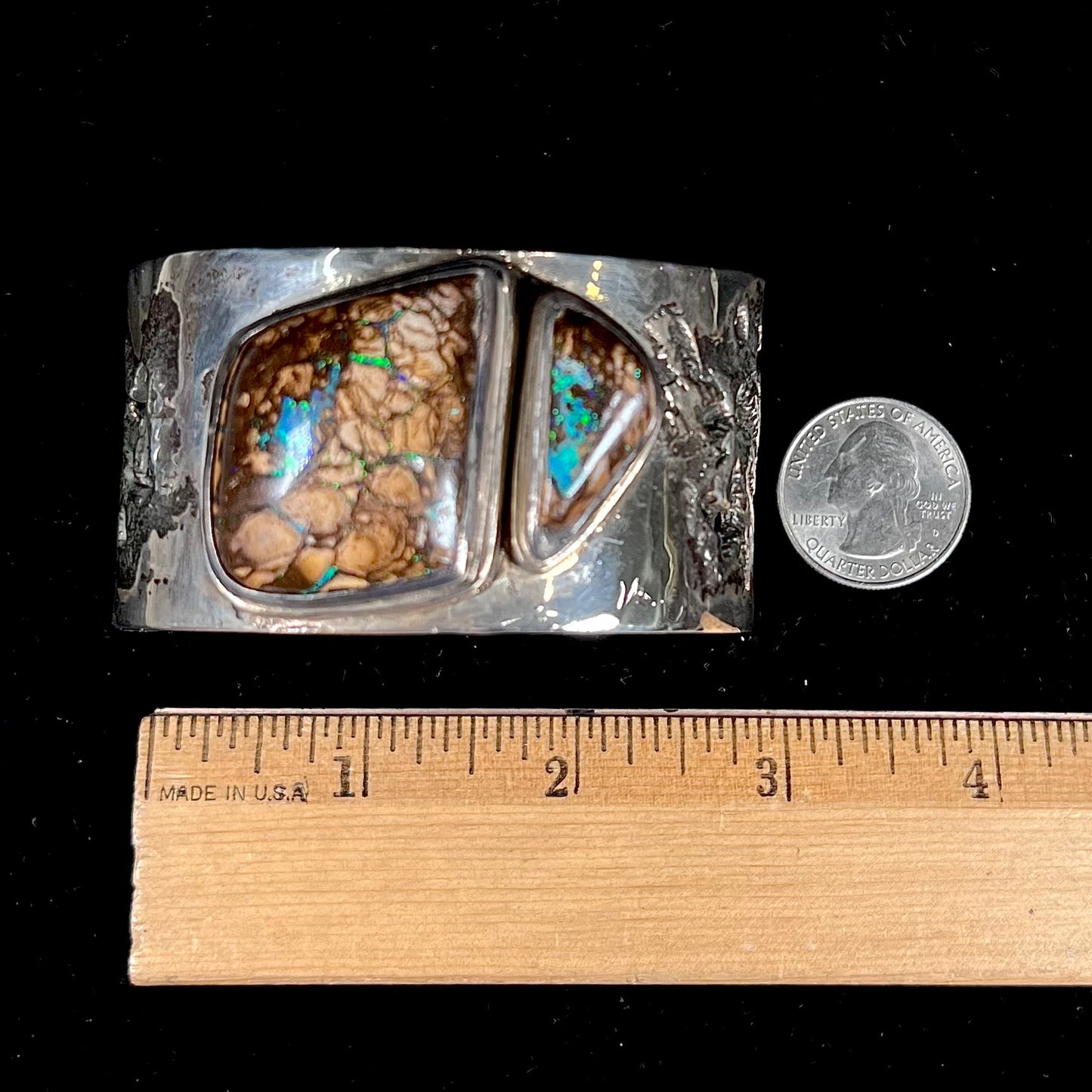 A men's sterling silver and copper infused cuff bracelet set with two boulder opal stones from Koroit, Australia.