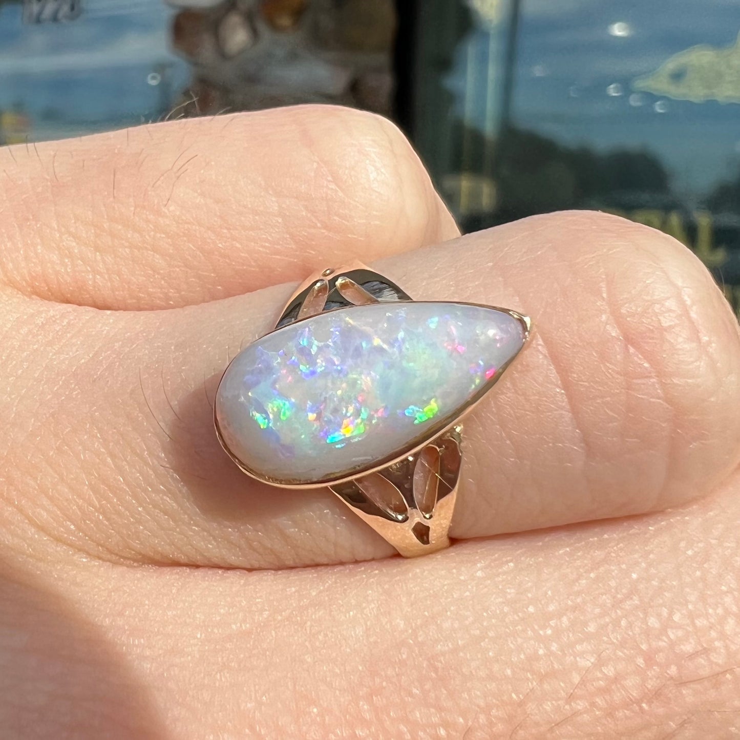 A ladies' pear shaped white crystal opal solitaire ring handmade in yellow gold.